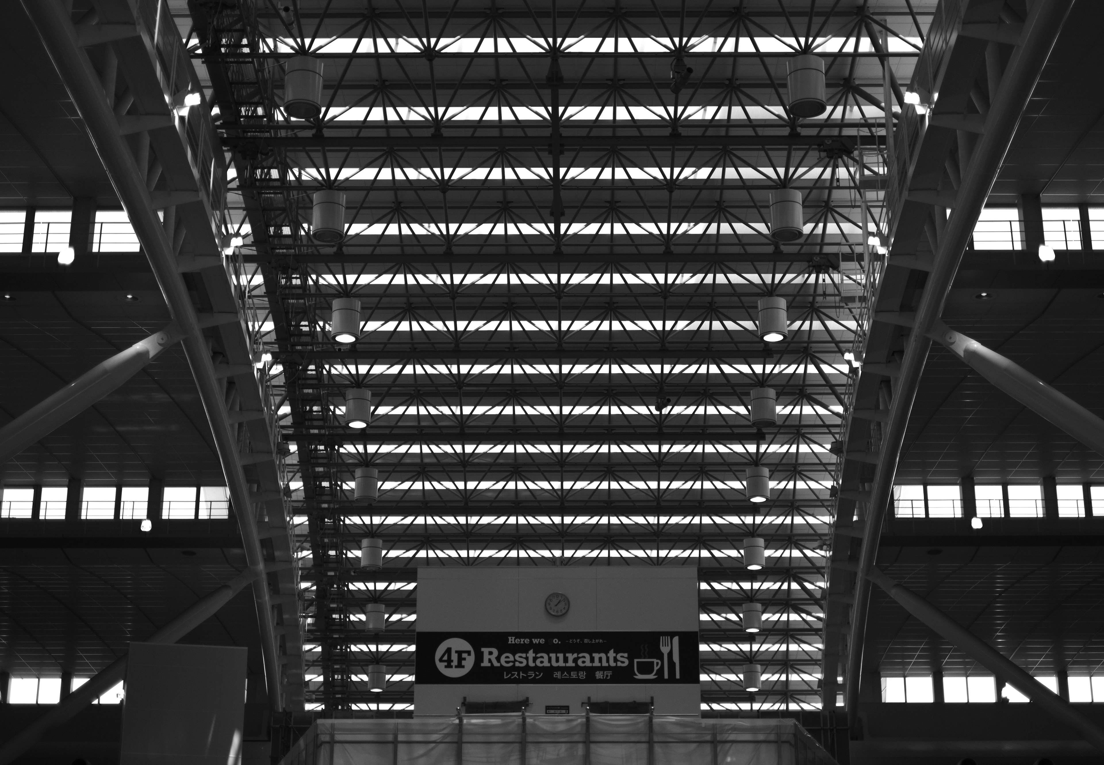 Image looking up at an indoor structure highlighted in black and white showcasing lines and shapes