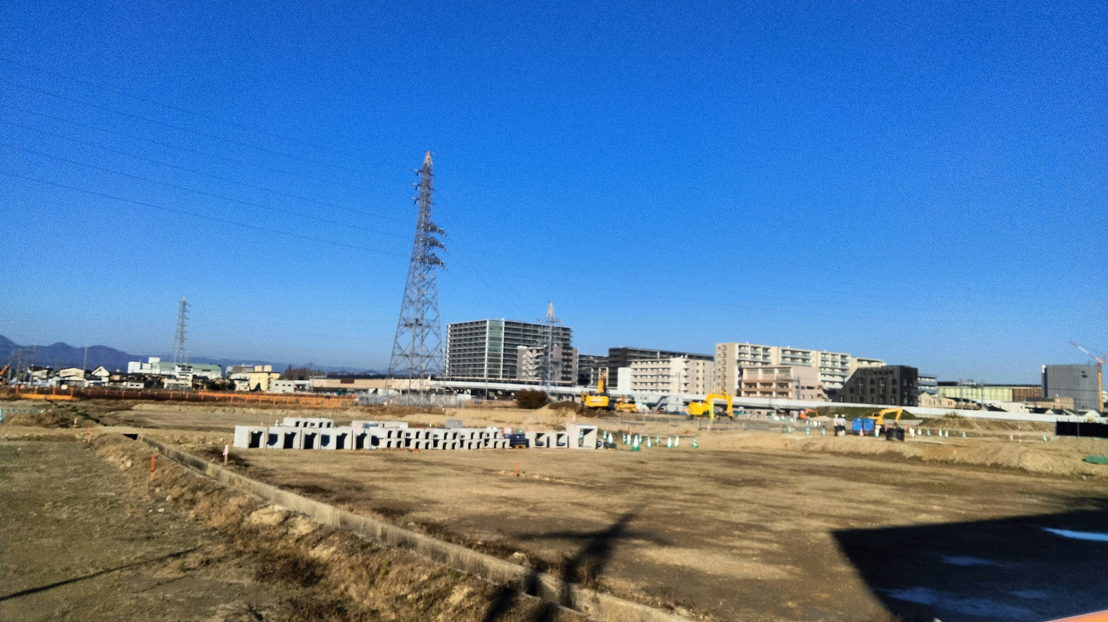 Wide construction site with clear blue sky