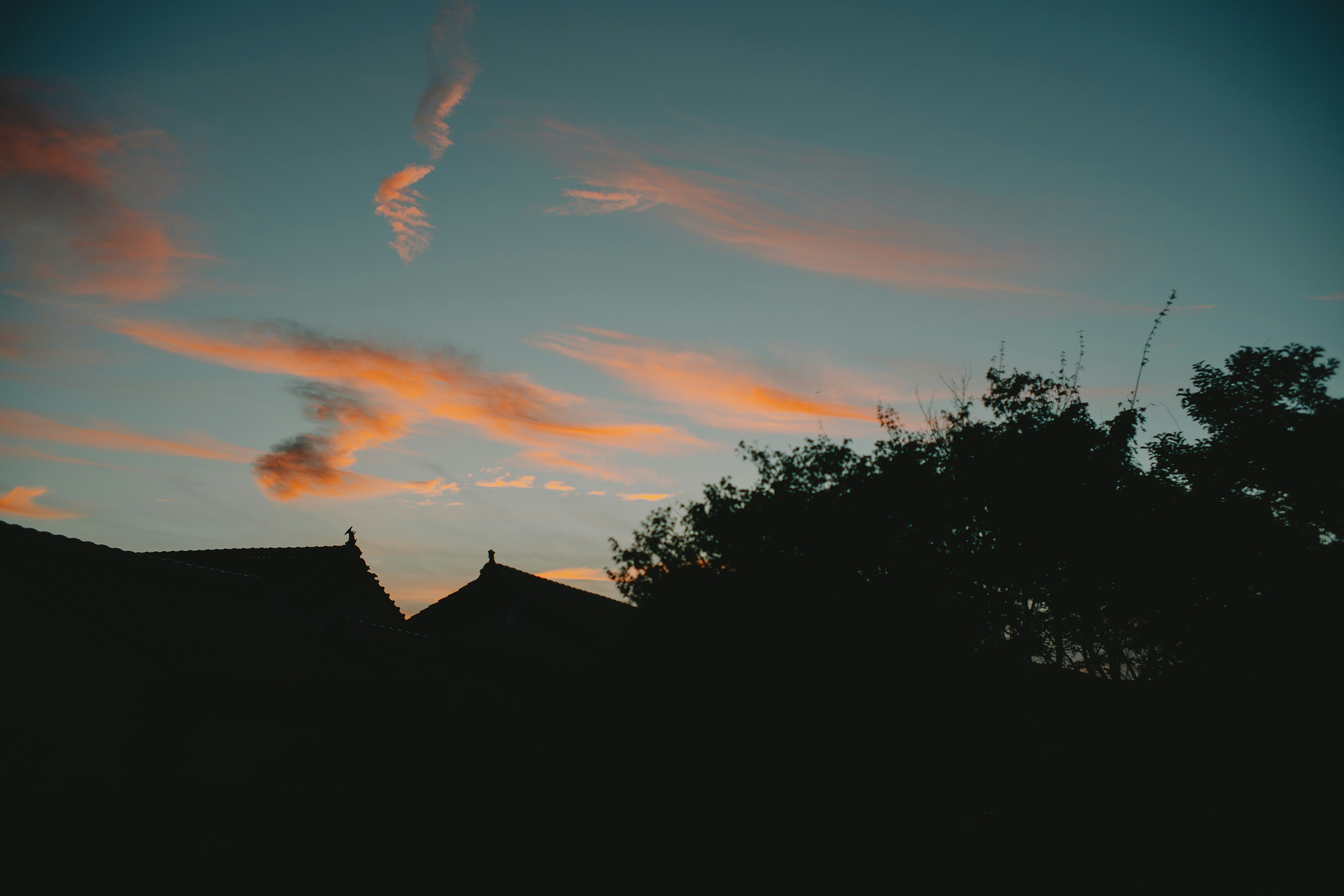 Silhouette of buildings against a sunset sky with colorful clouds