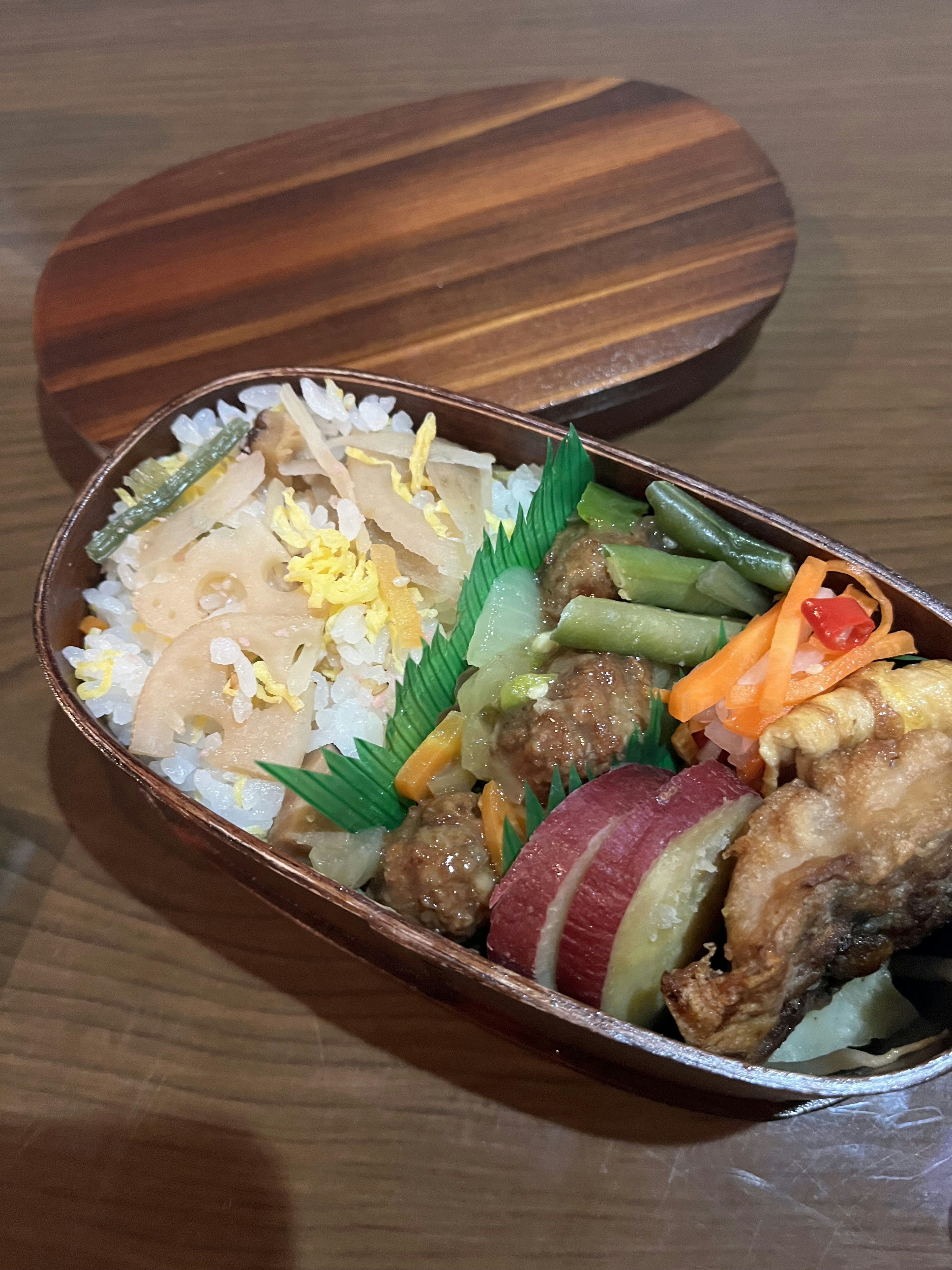 Beautiful bento box filled with rice and side dishes colorful food items fried chicken vegetables