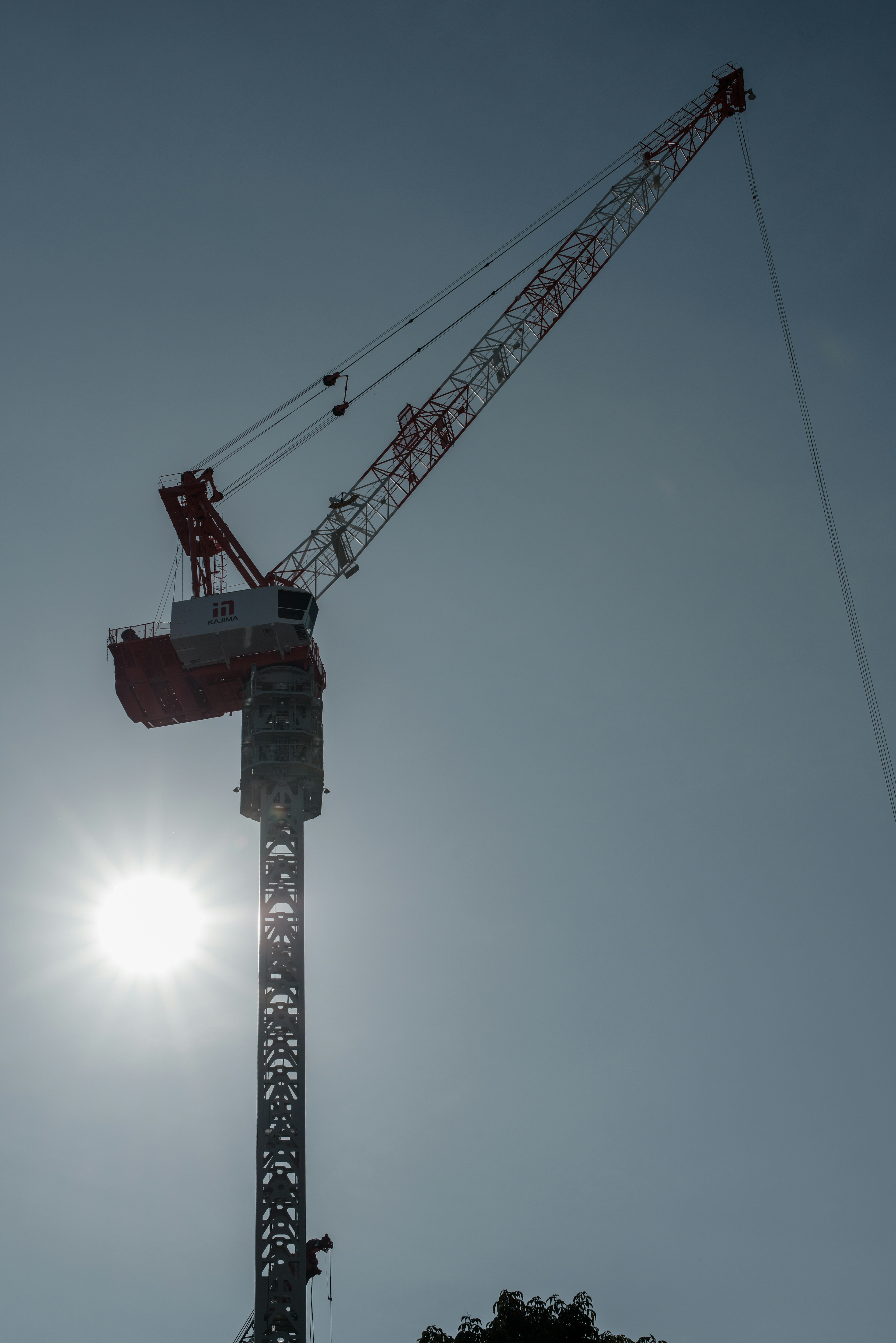 Construction crane towering against a clear blue sky