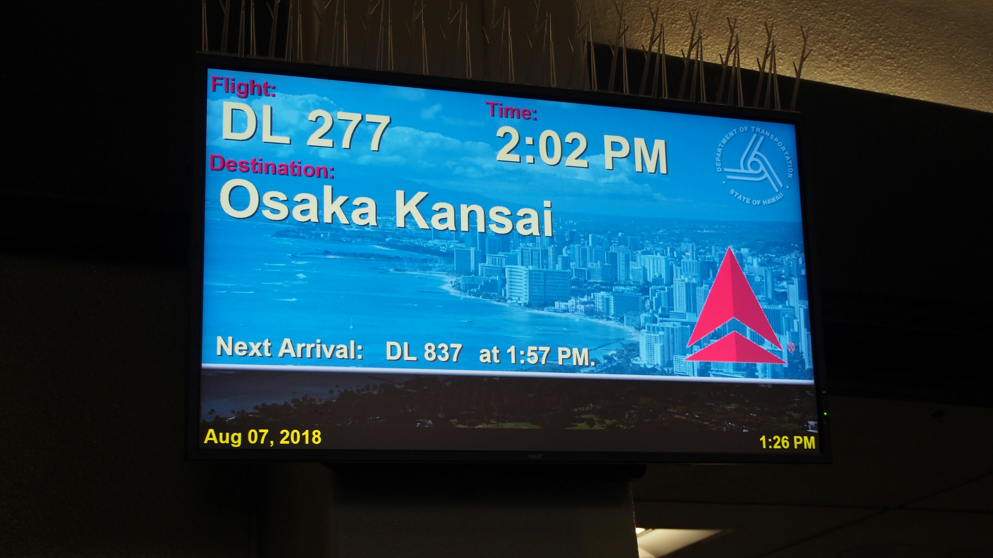 Pantalla de información de vuelo que muestra la salida del DL 277 y el destino Osaka Kansai