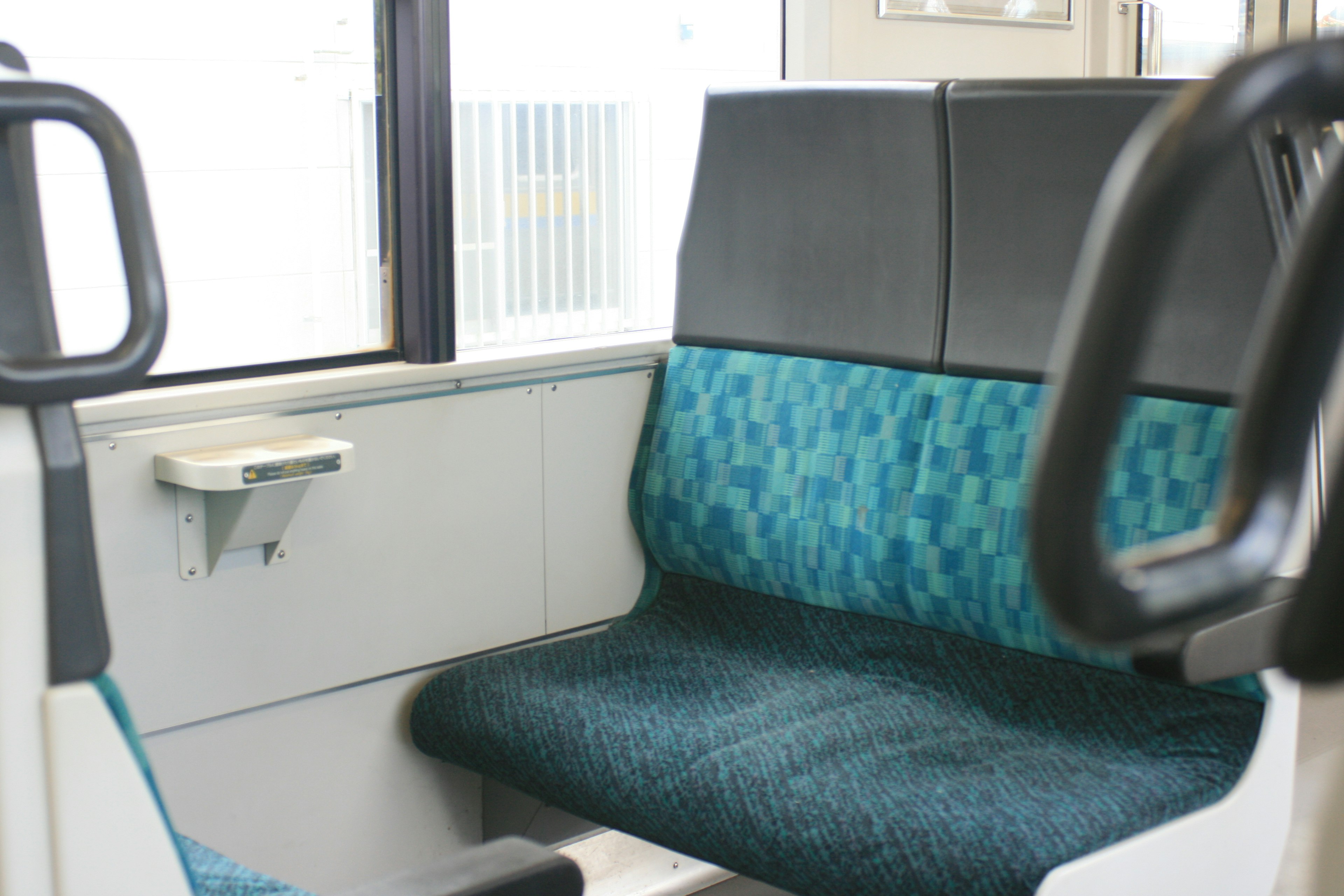 Interior of a train car featuring blue and black seating