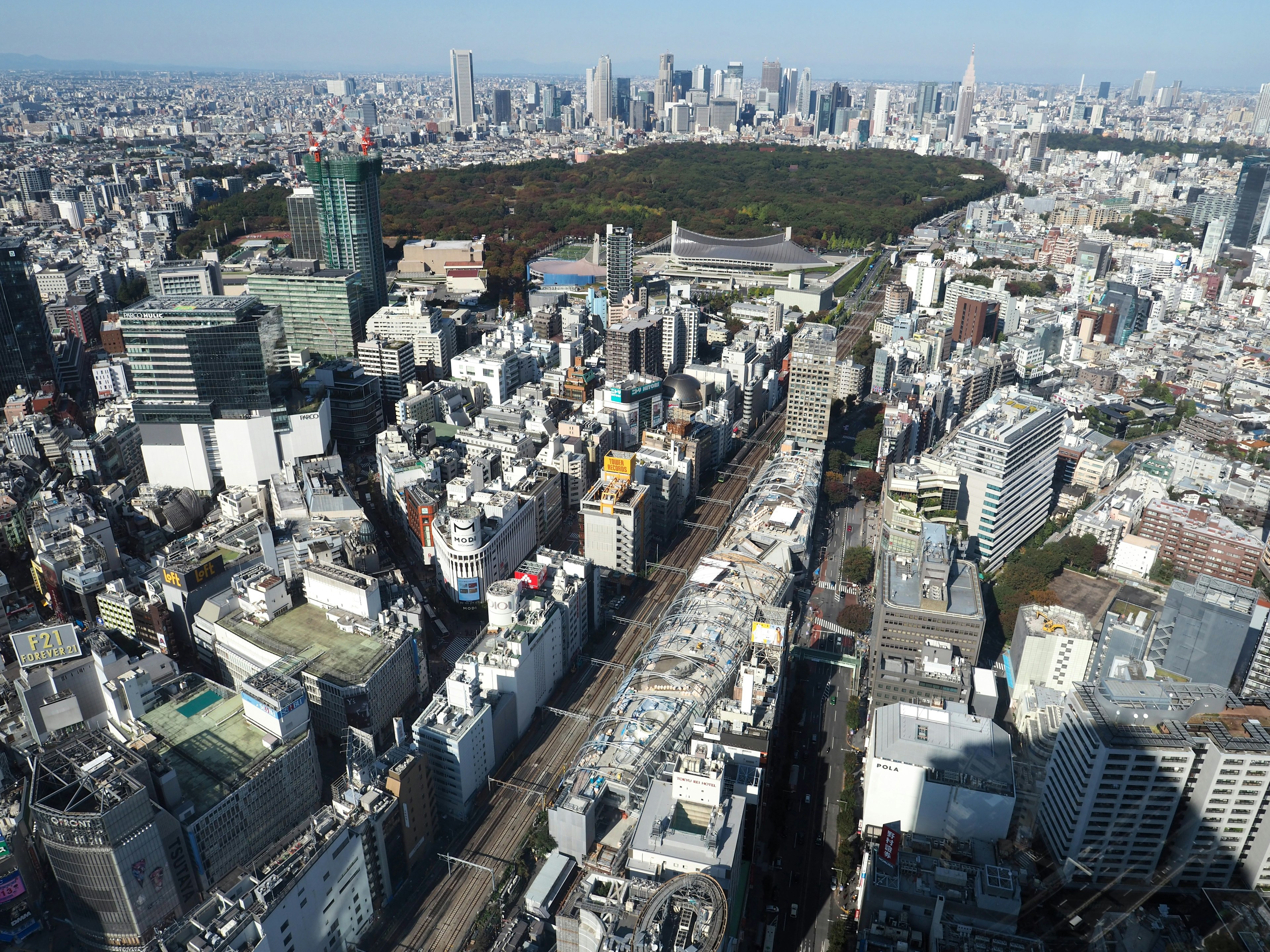 Aerial view of Tokyo showcasing skyscrapers and a green park