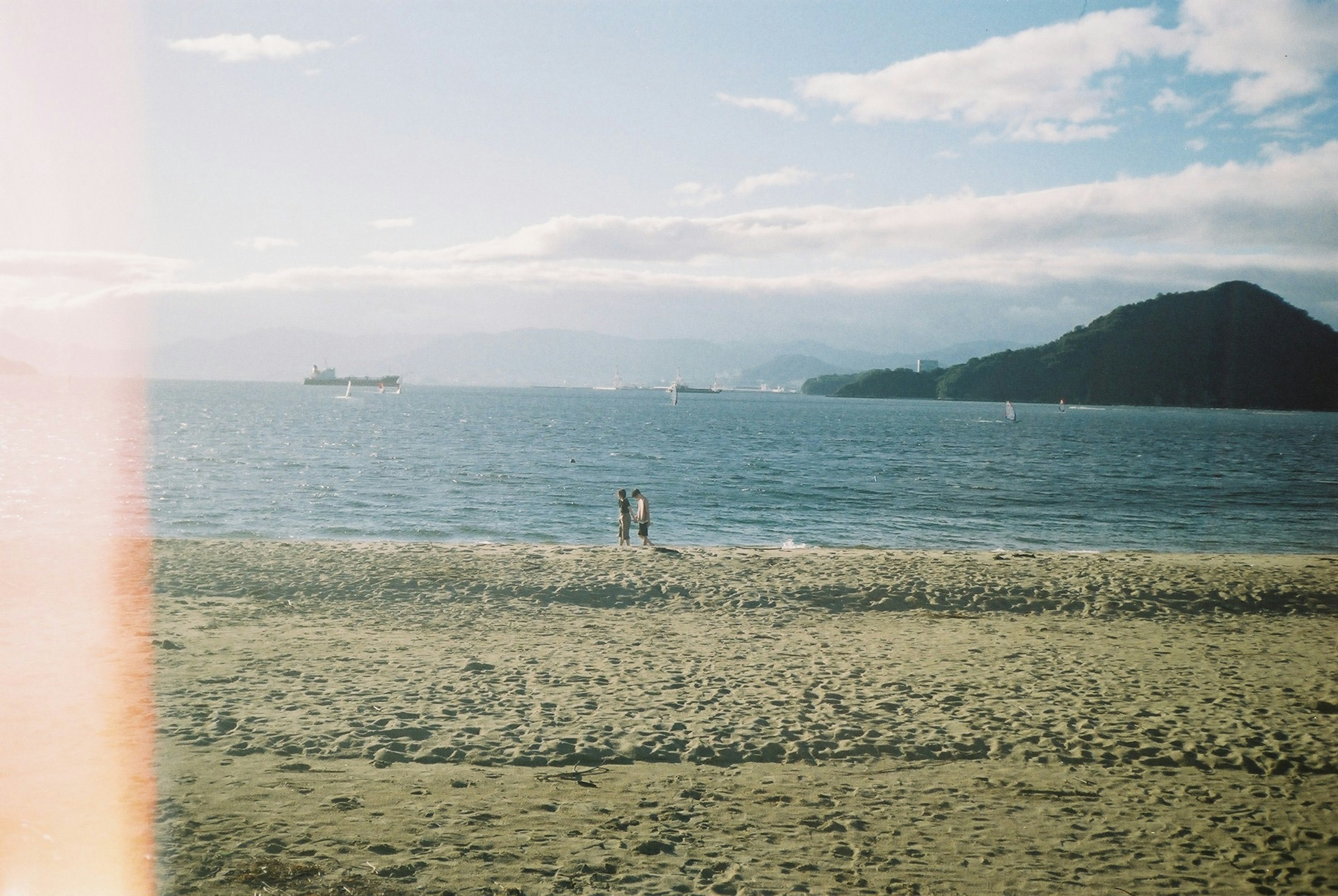 海岸で人々が海を見つめる風景