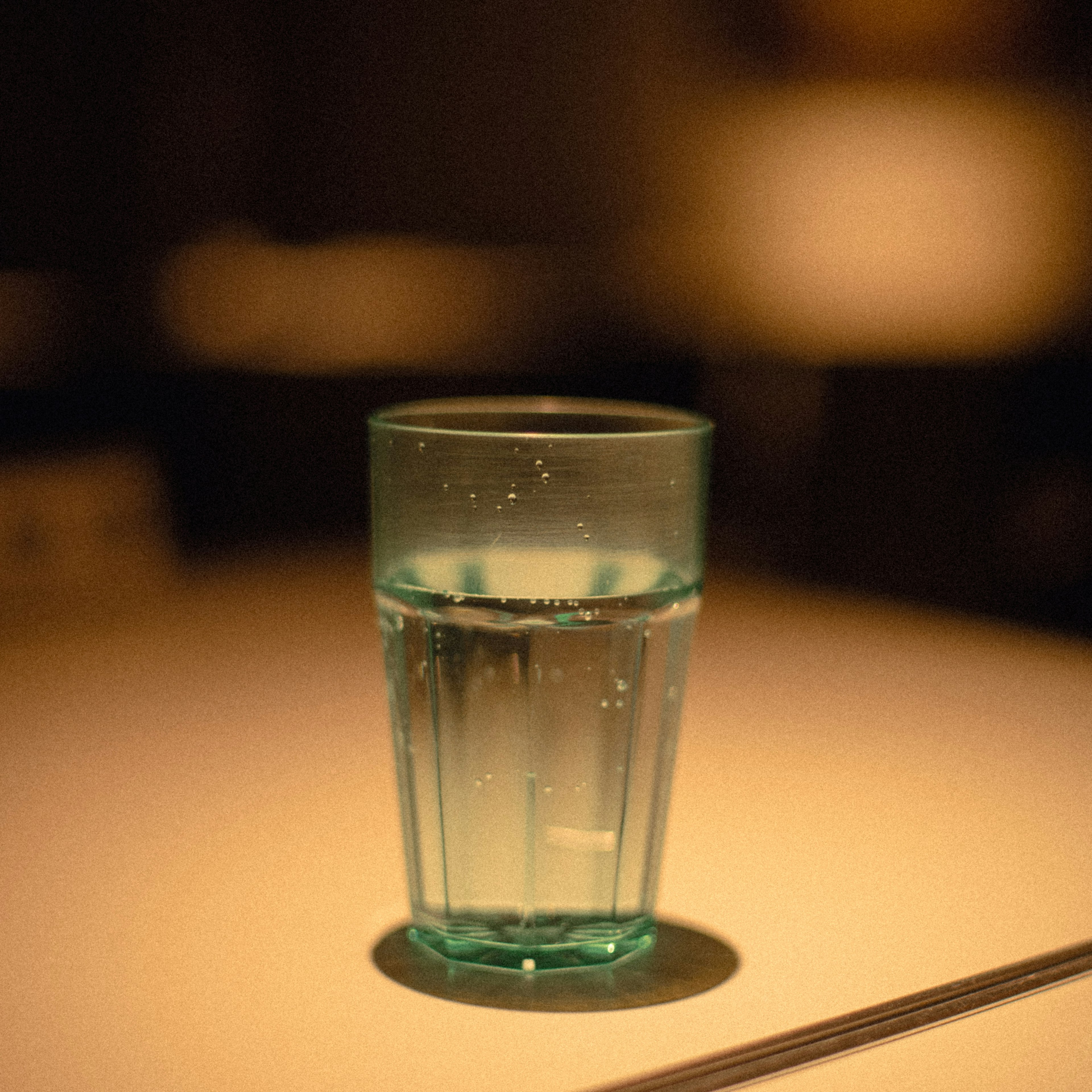 A blue glass of water placed on a table