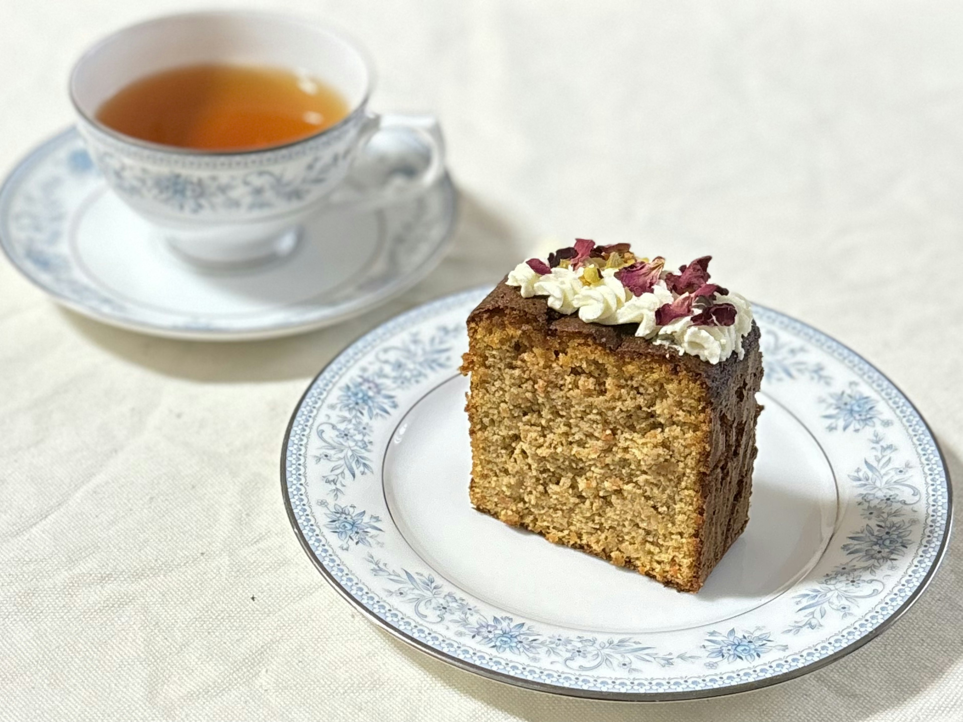 紅茶とケーキのプレートがある美しいテーブルセッティング