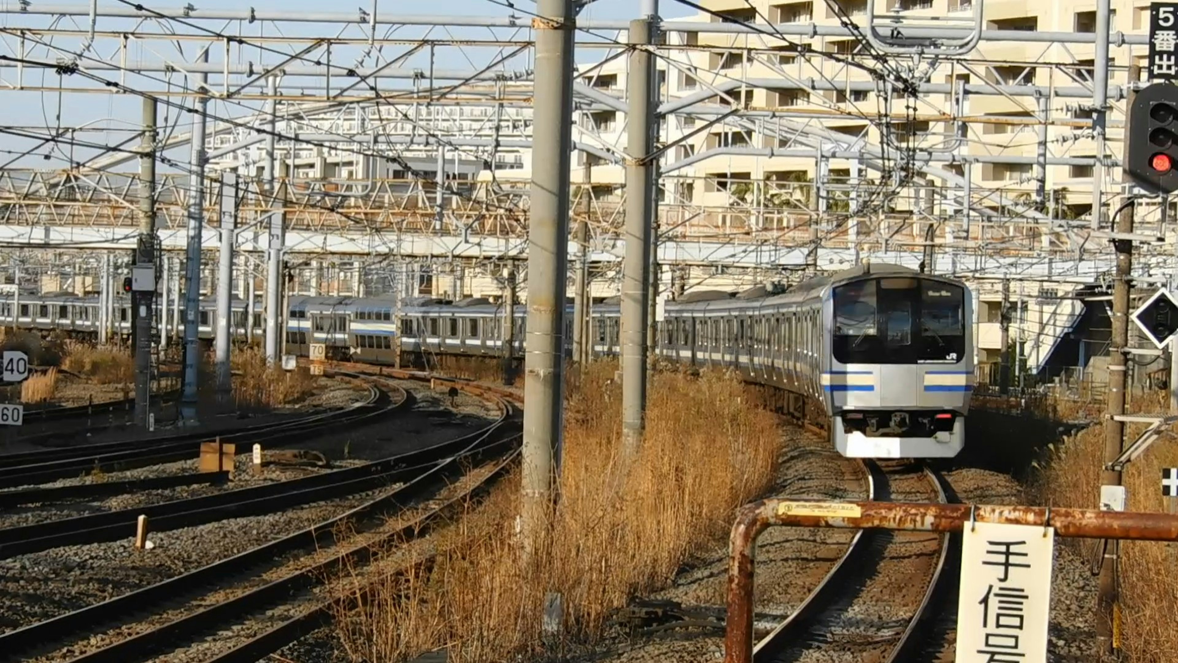 A railway scene with tracks and a train approaching