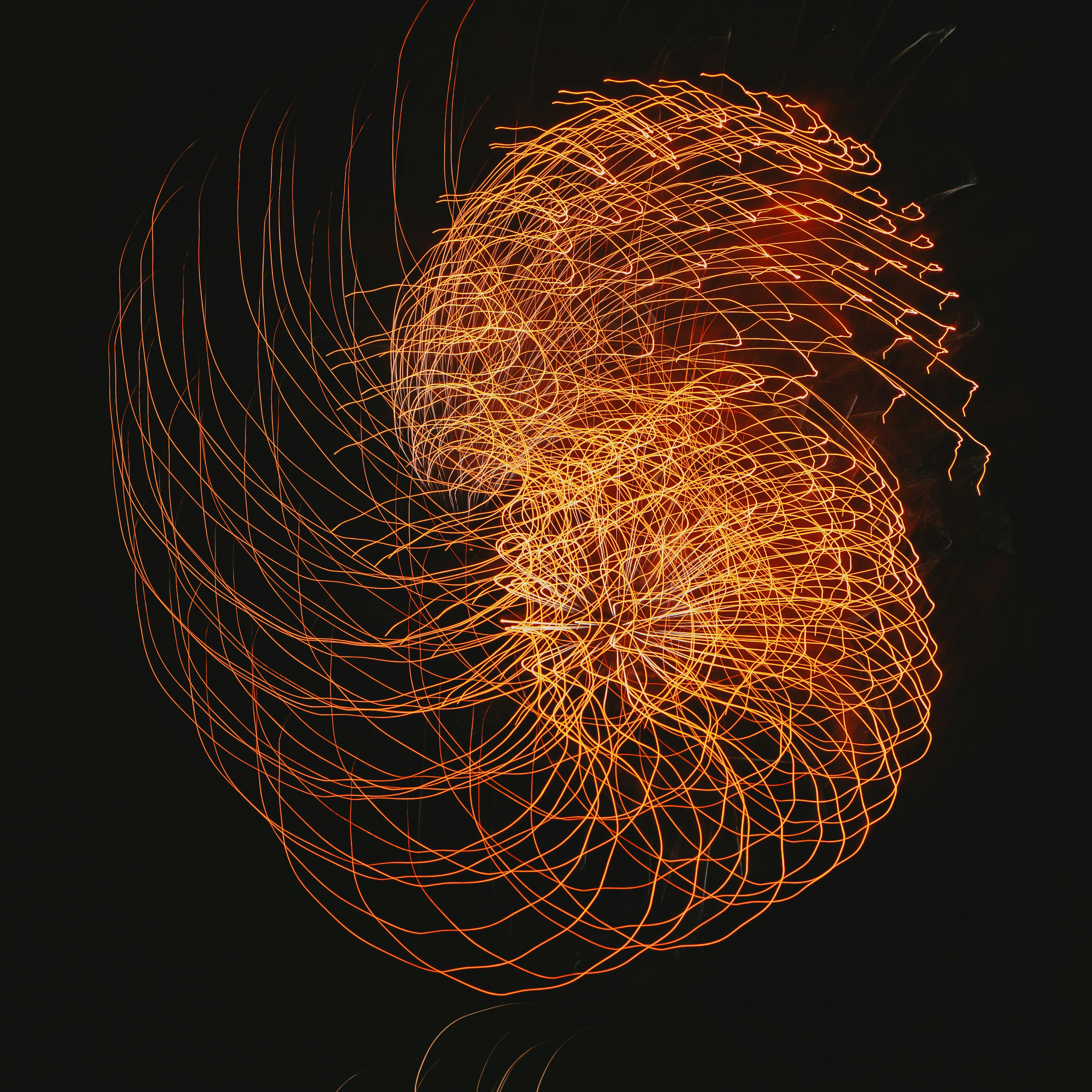 Une œuvre d'art abstraite avec une lumière orange tourbillonnante sur un fond sombre