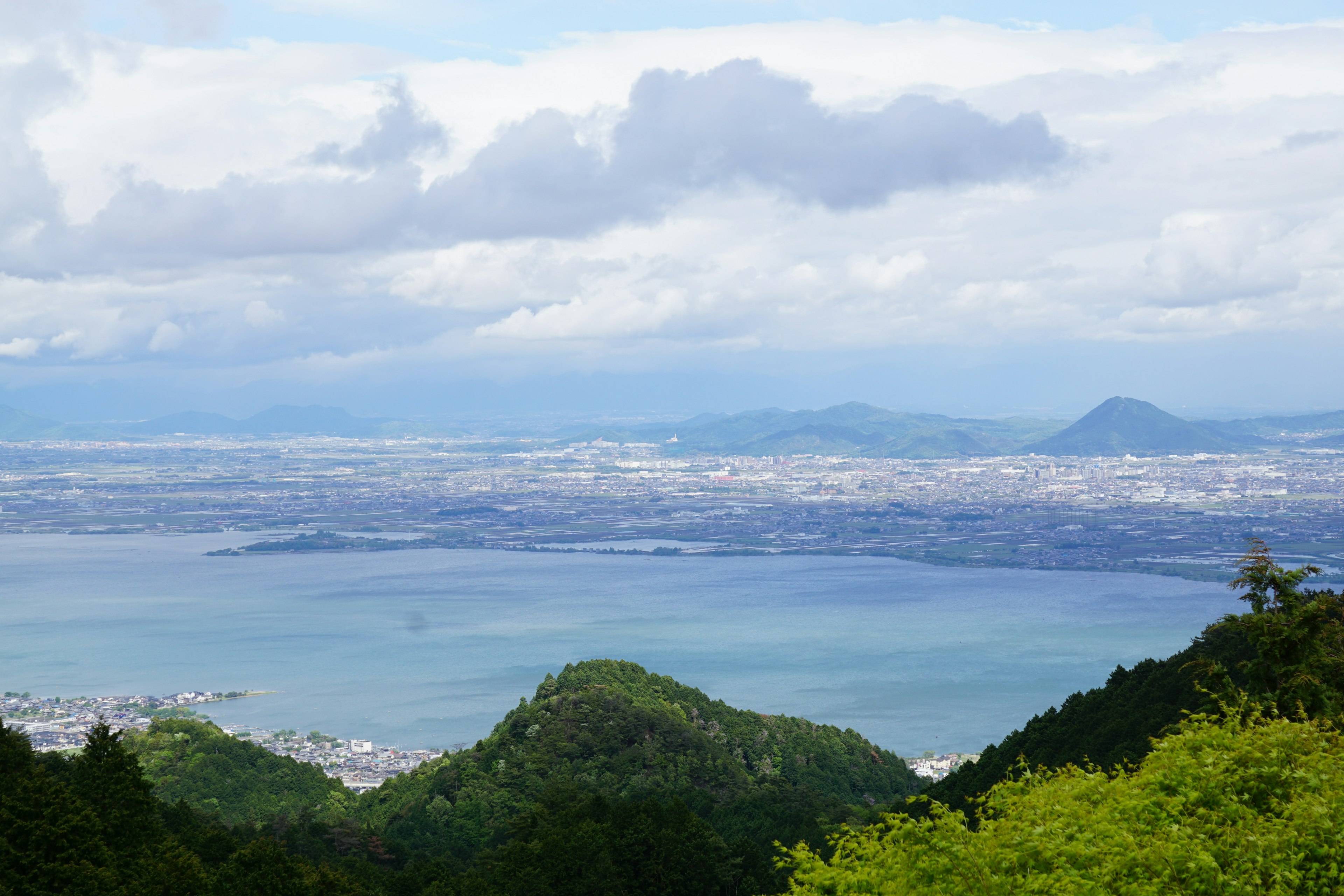 Scenic view of blue sea and green mountains