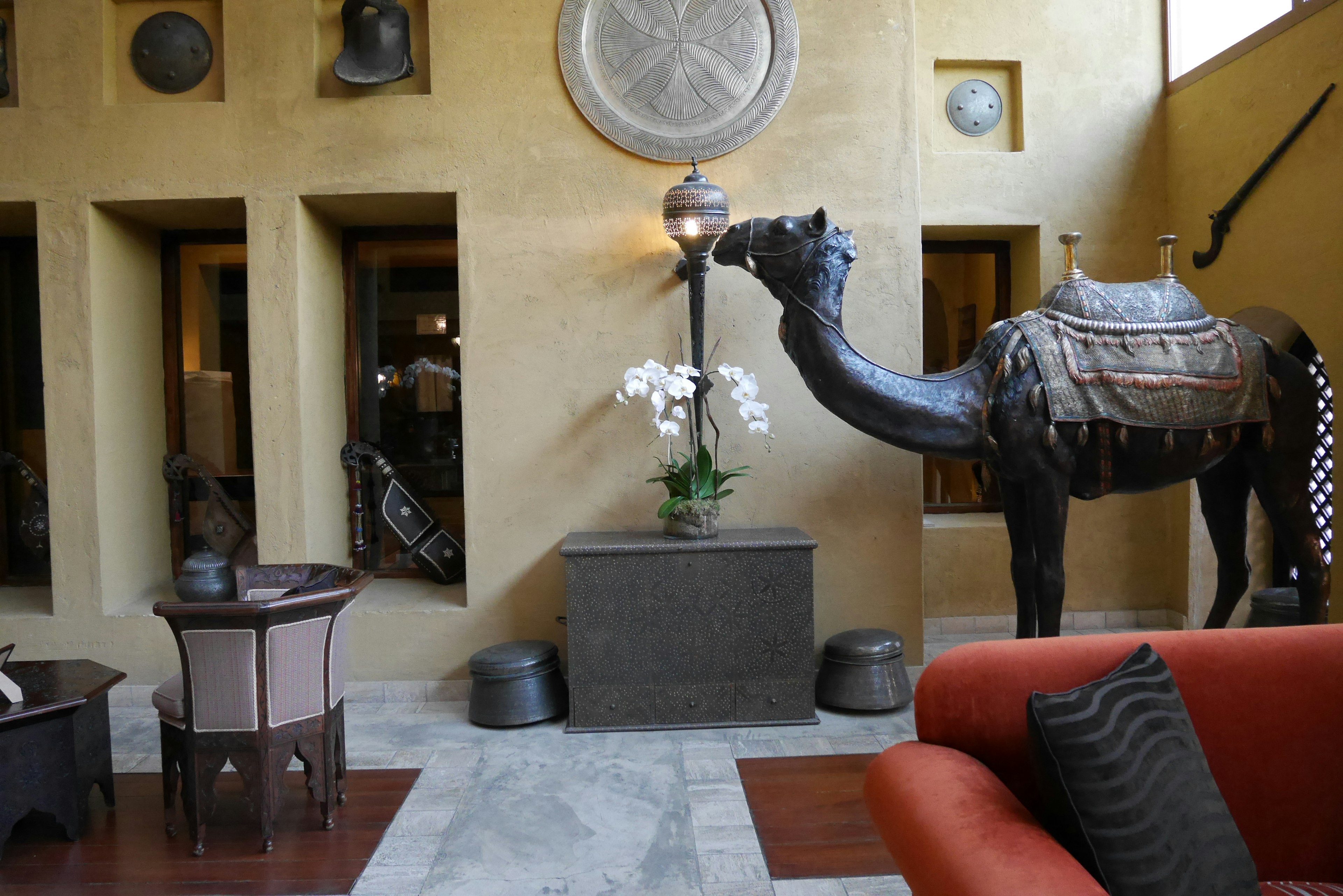 Decorative camel statue and floral arrangement in a stylish interior