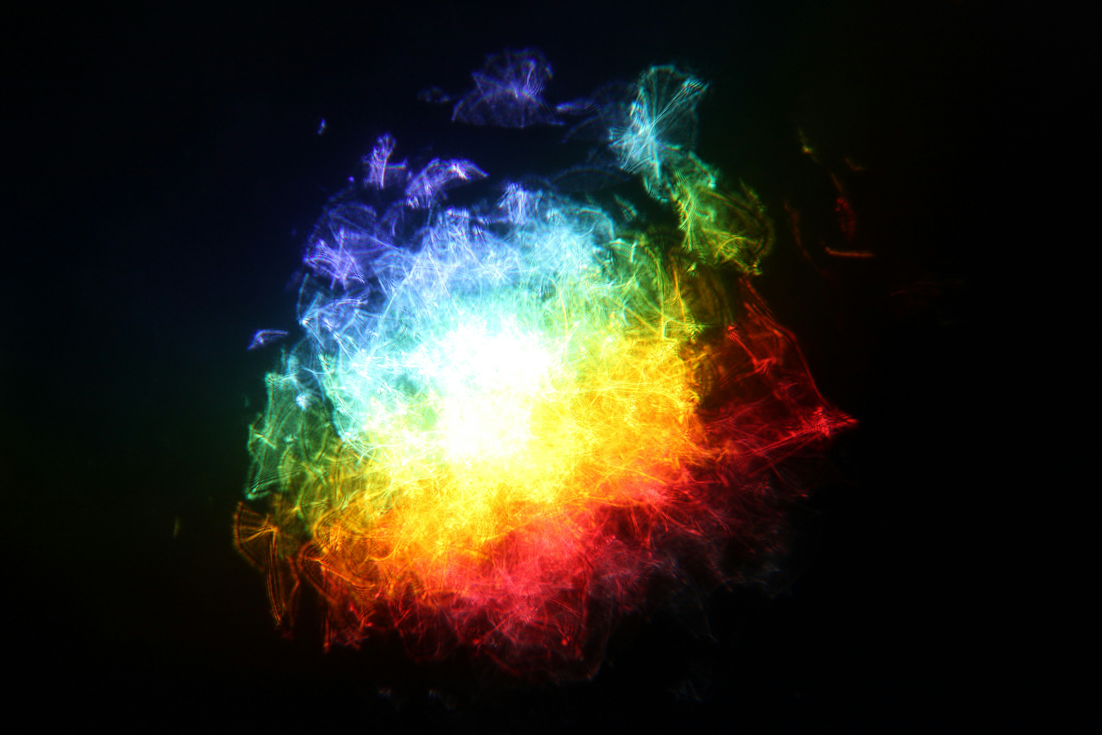 A vibrant explosion of colorful light resembling ethereal smoke