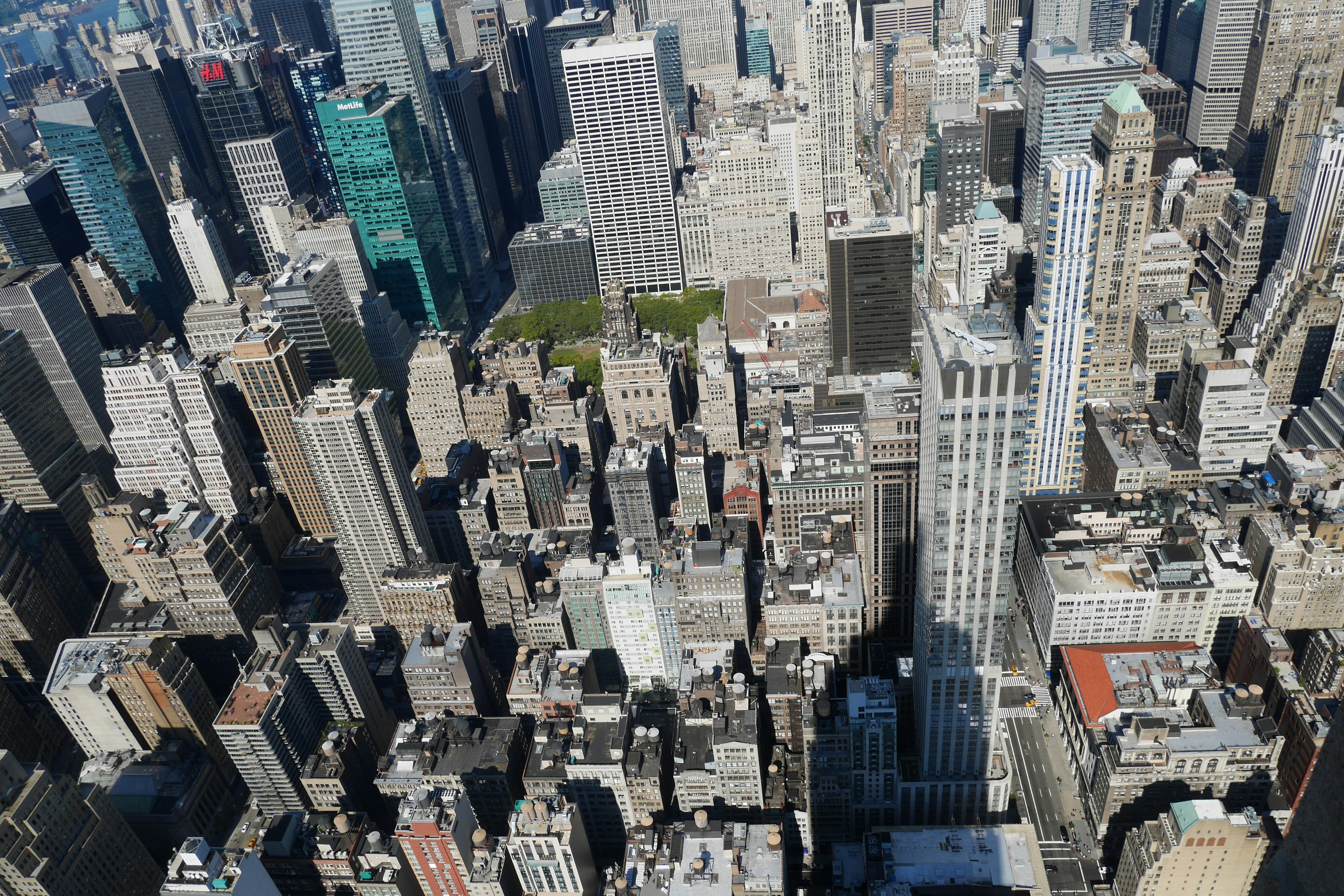 Aerial view of New York City skyscrapers featuring a green space