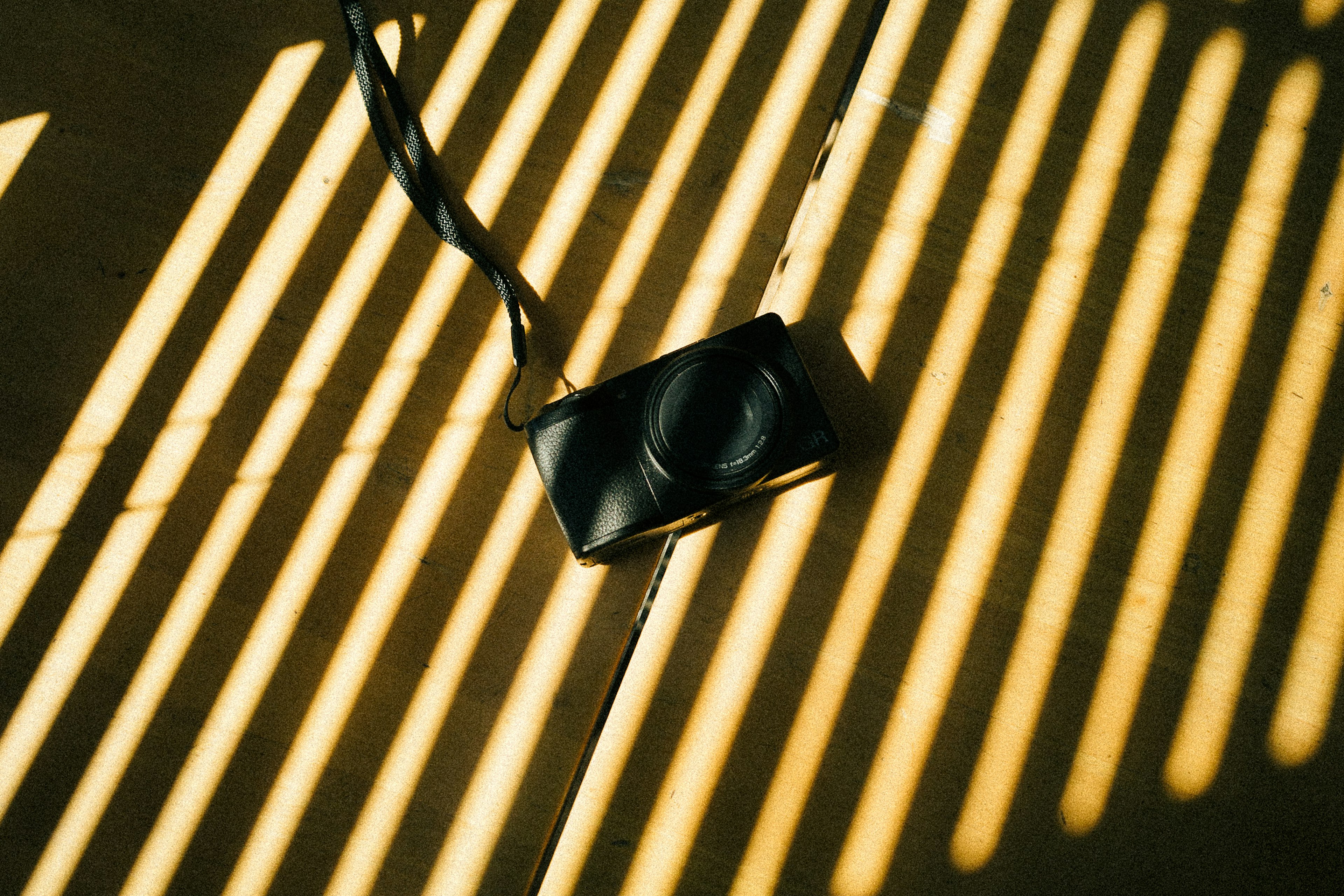 Camera placed on striped shadows and light