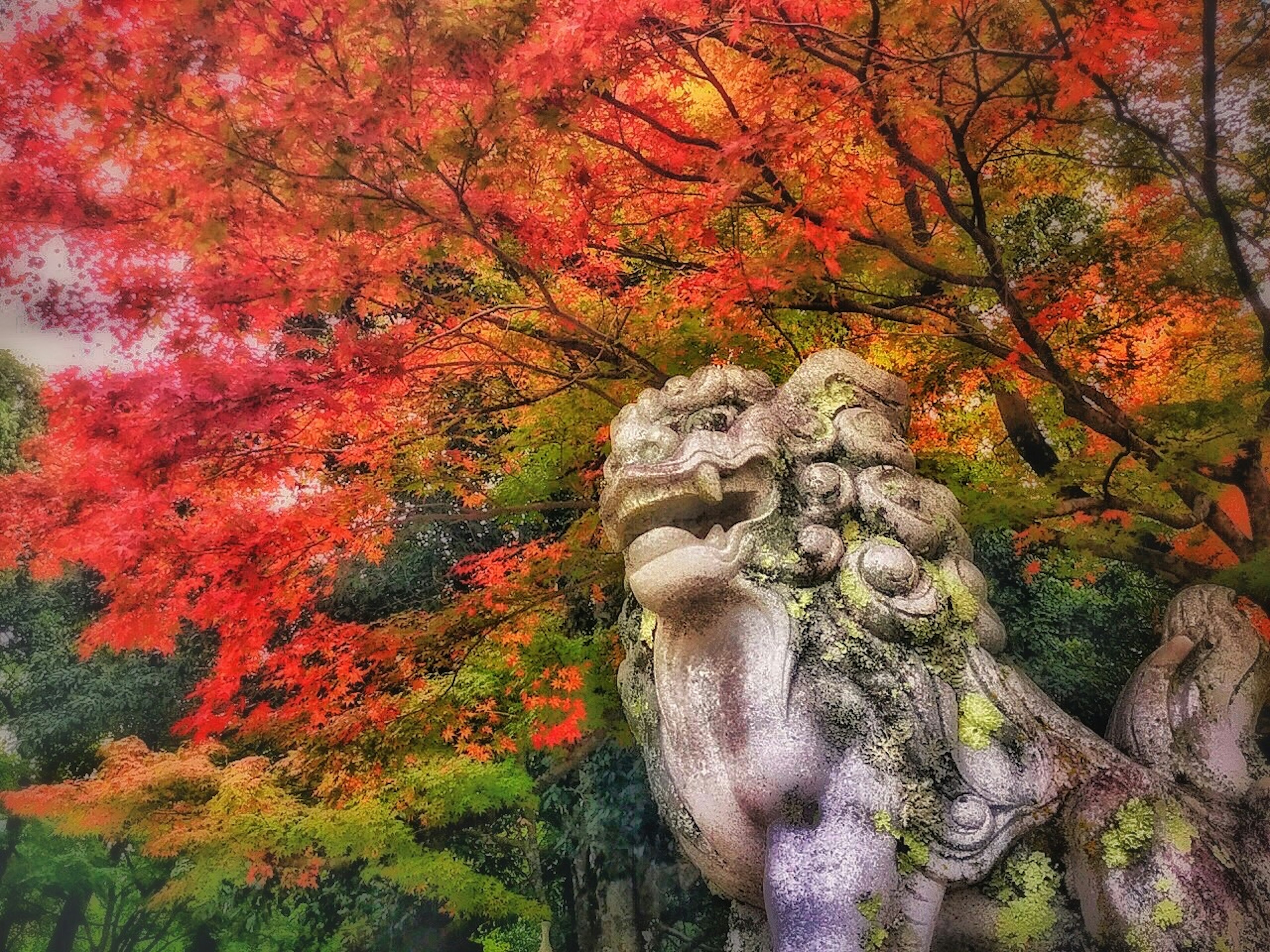 Escultura de león de piedra rodeada de follaje otoñal vibrante