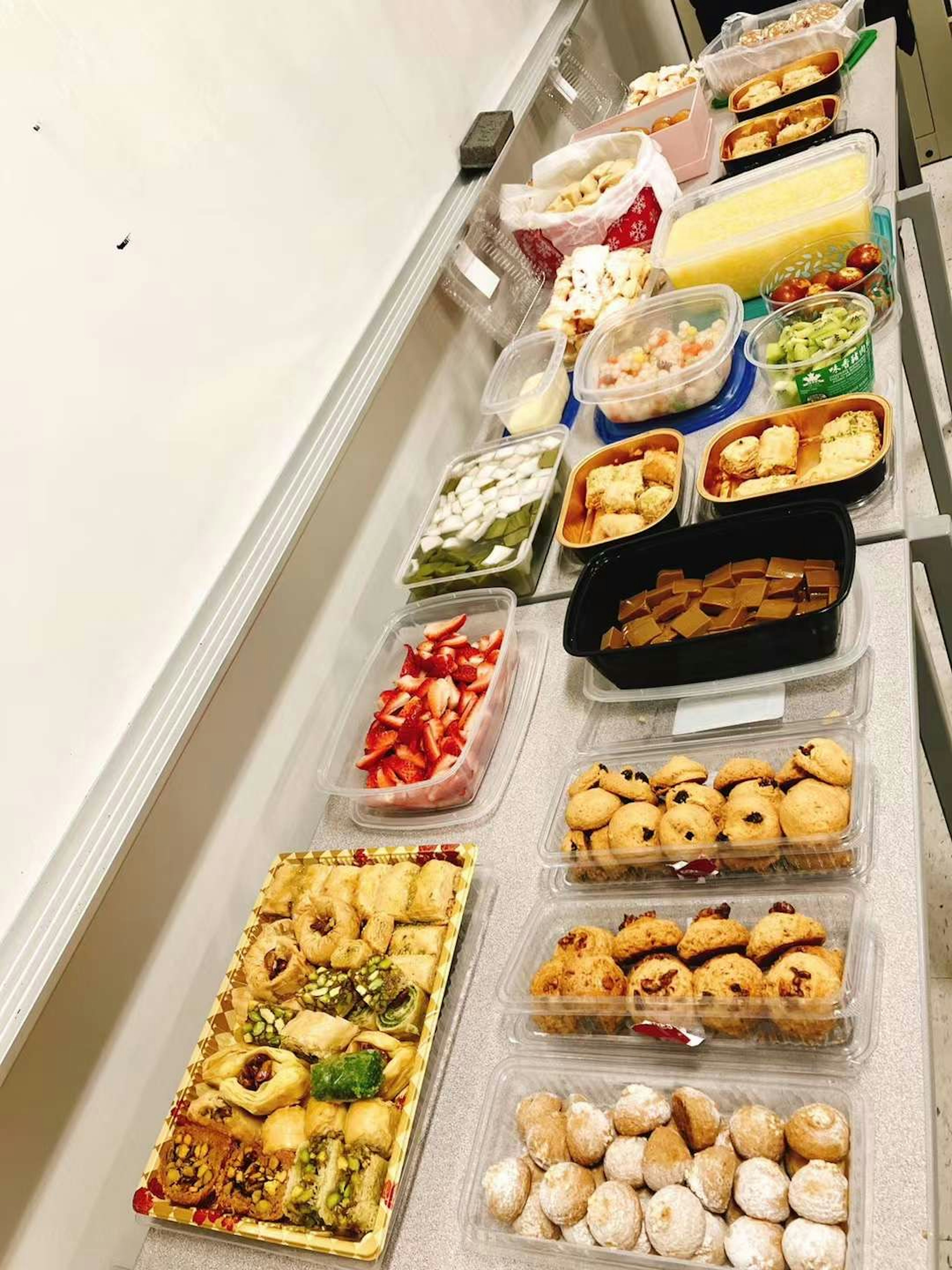 A spread of various dishes arranged on a table with colorful containers