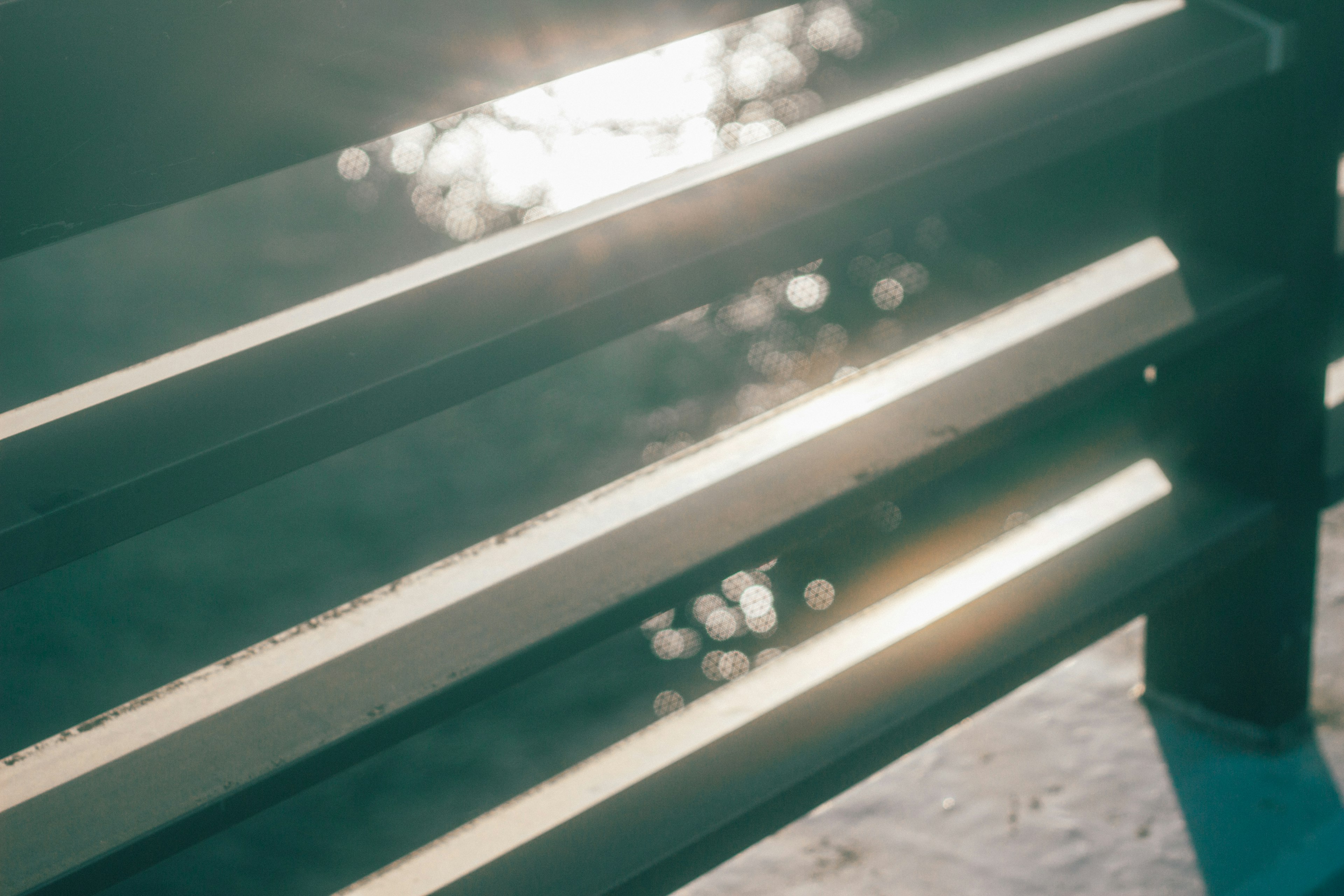 Sunlight streaming through a bench slats