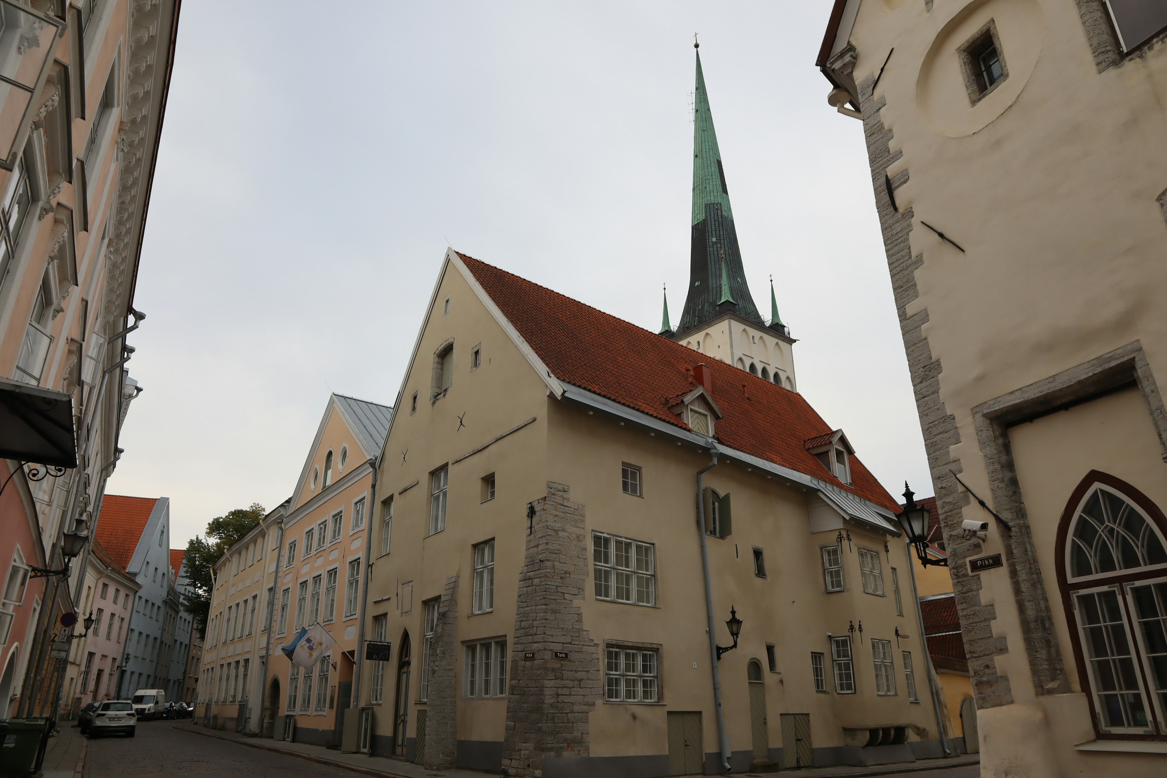 Street view featuring old buildings and a spire