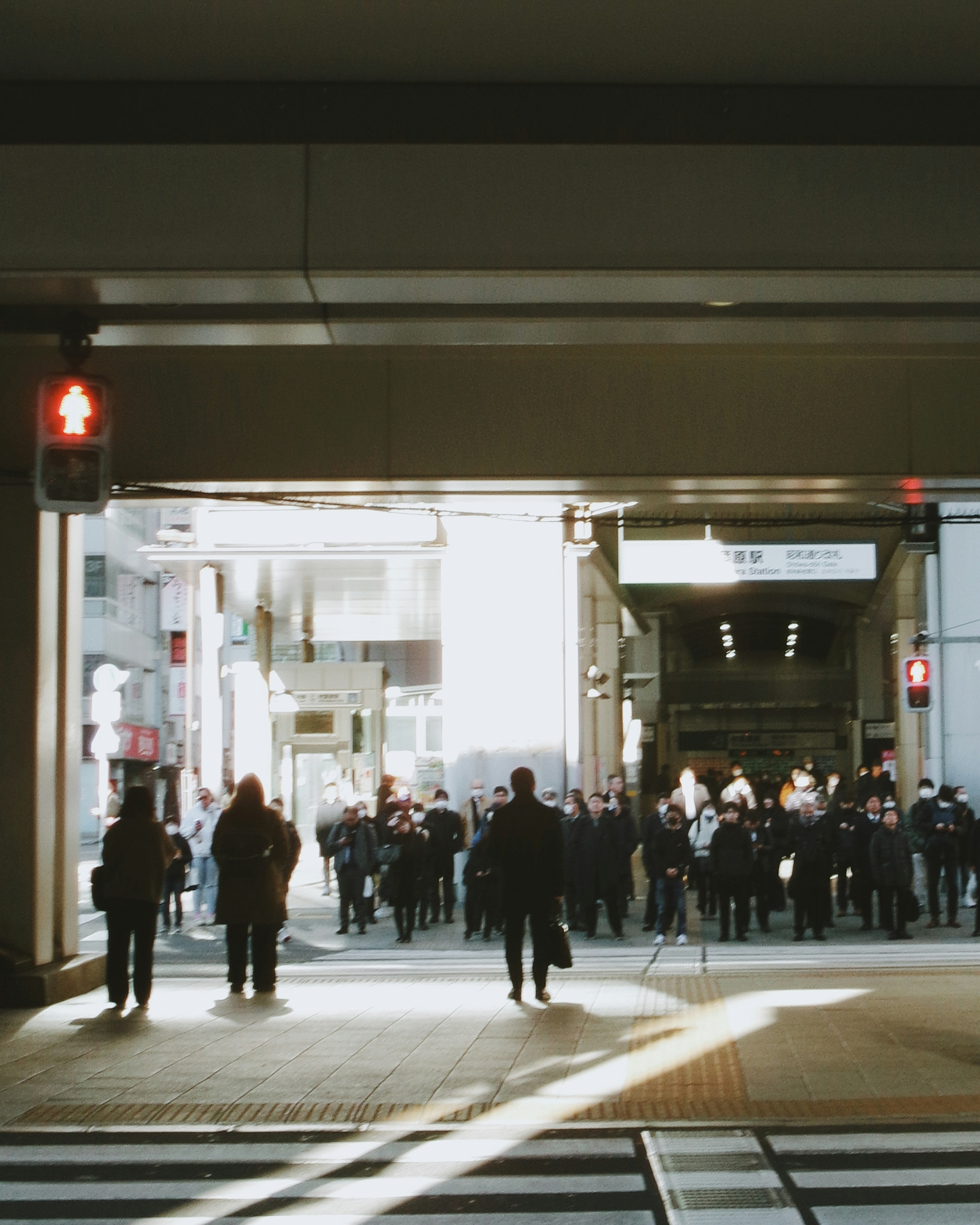 Urban scene of people waiting at a traffic signal