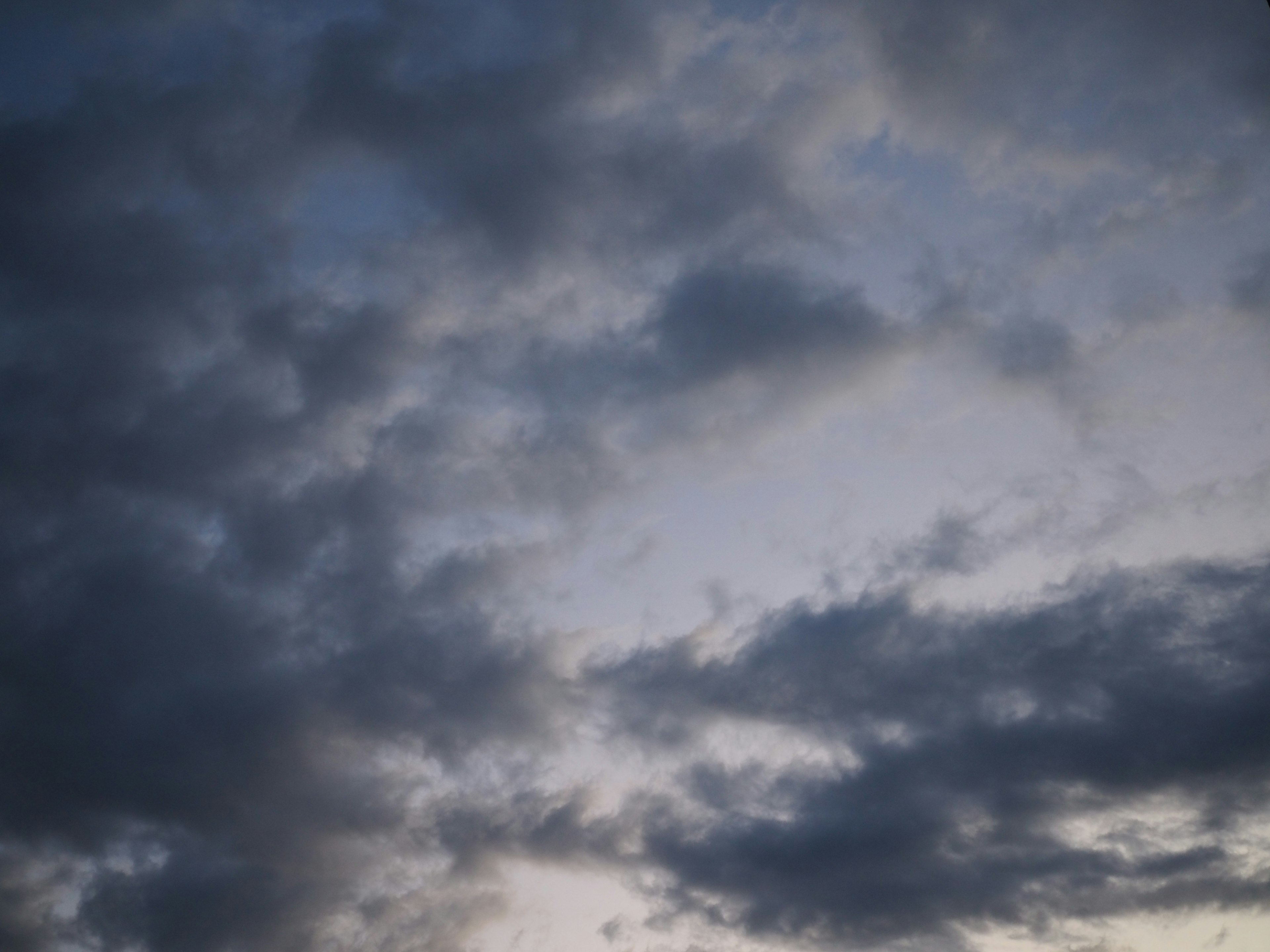 Dark clouds spread across the evening sky