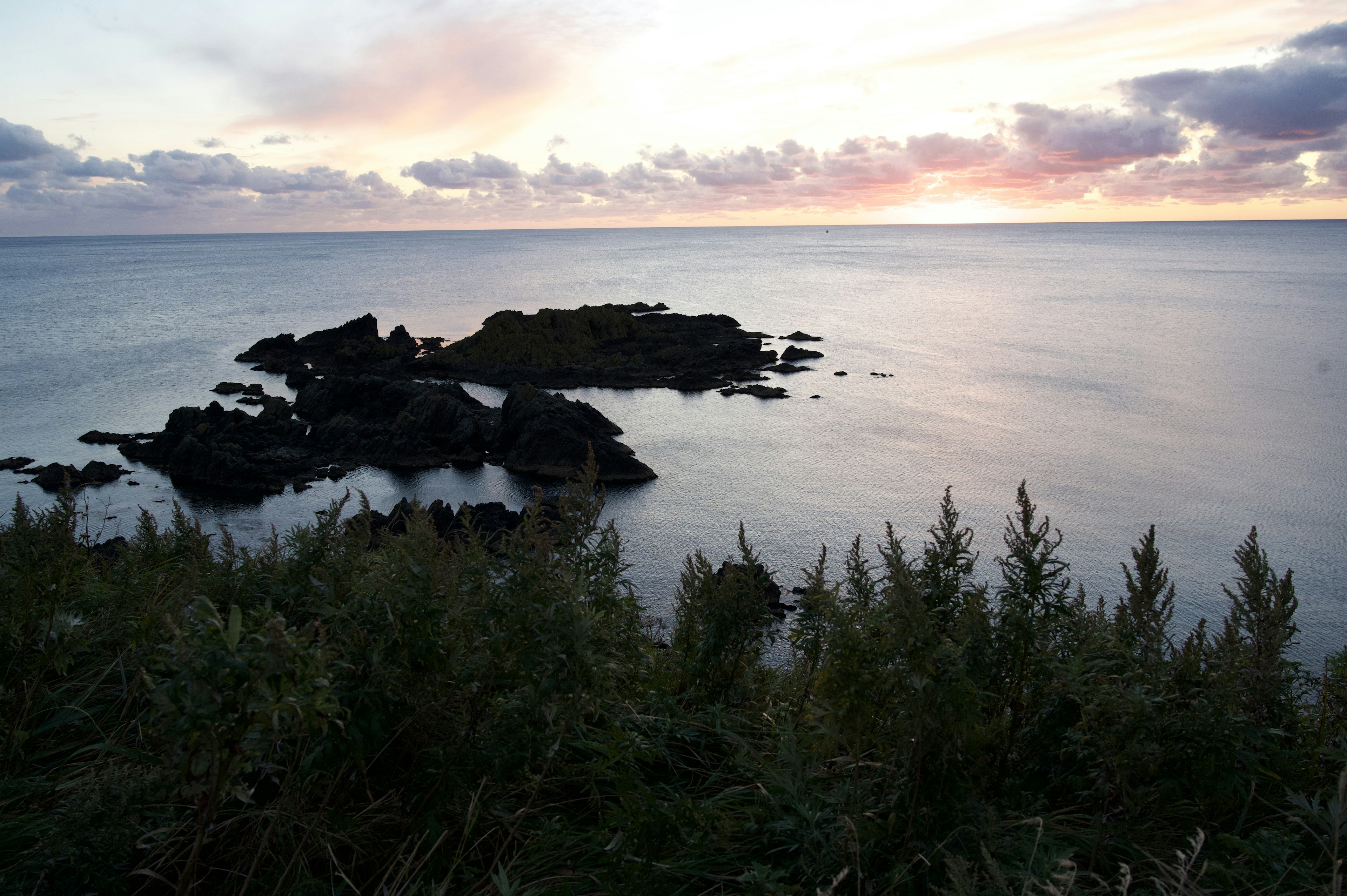 海と岩の美しい風景夕焼けの空に映える