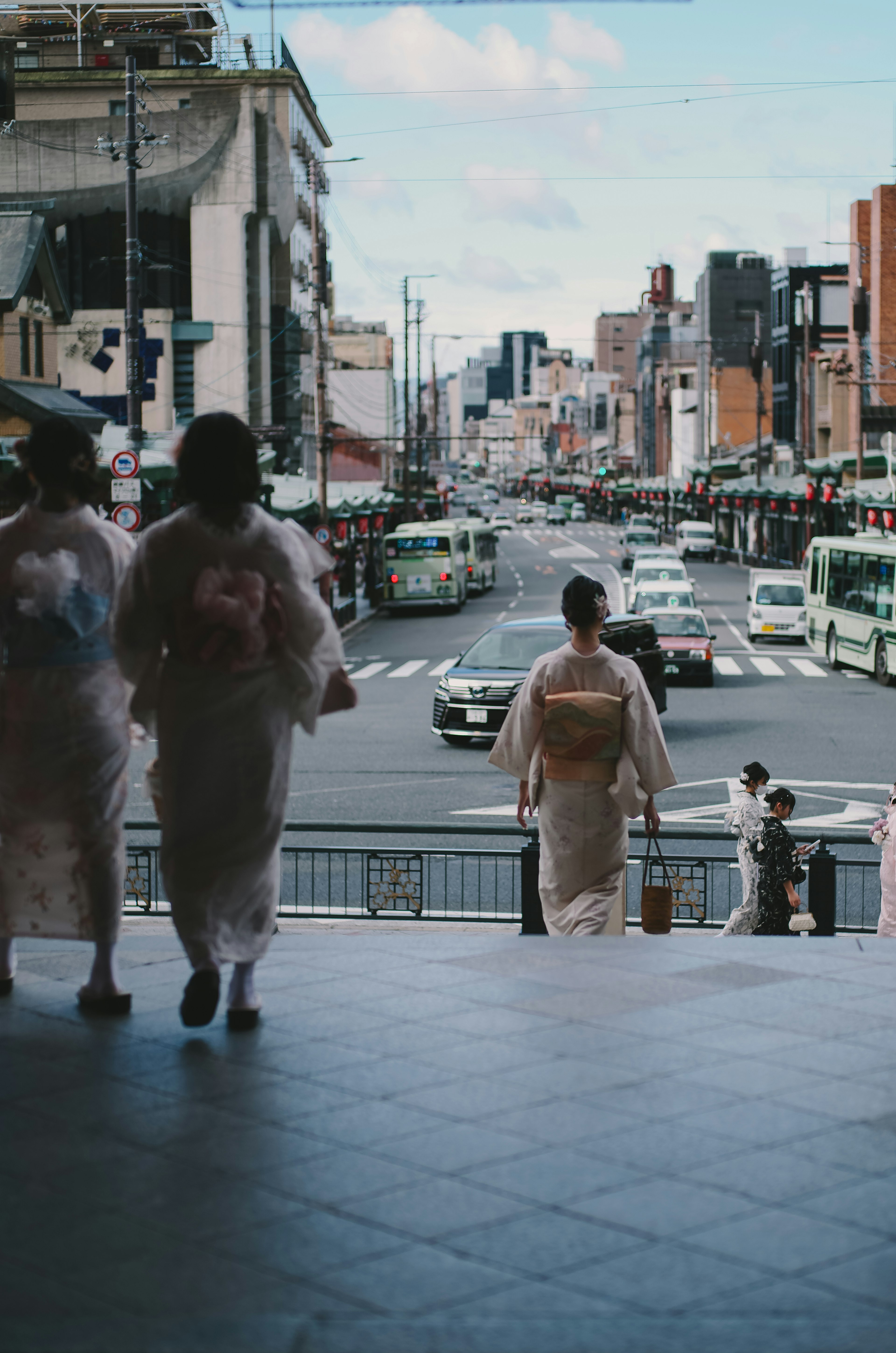 Women in kimonos walking in a city street