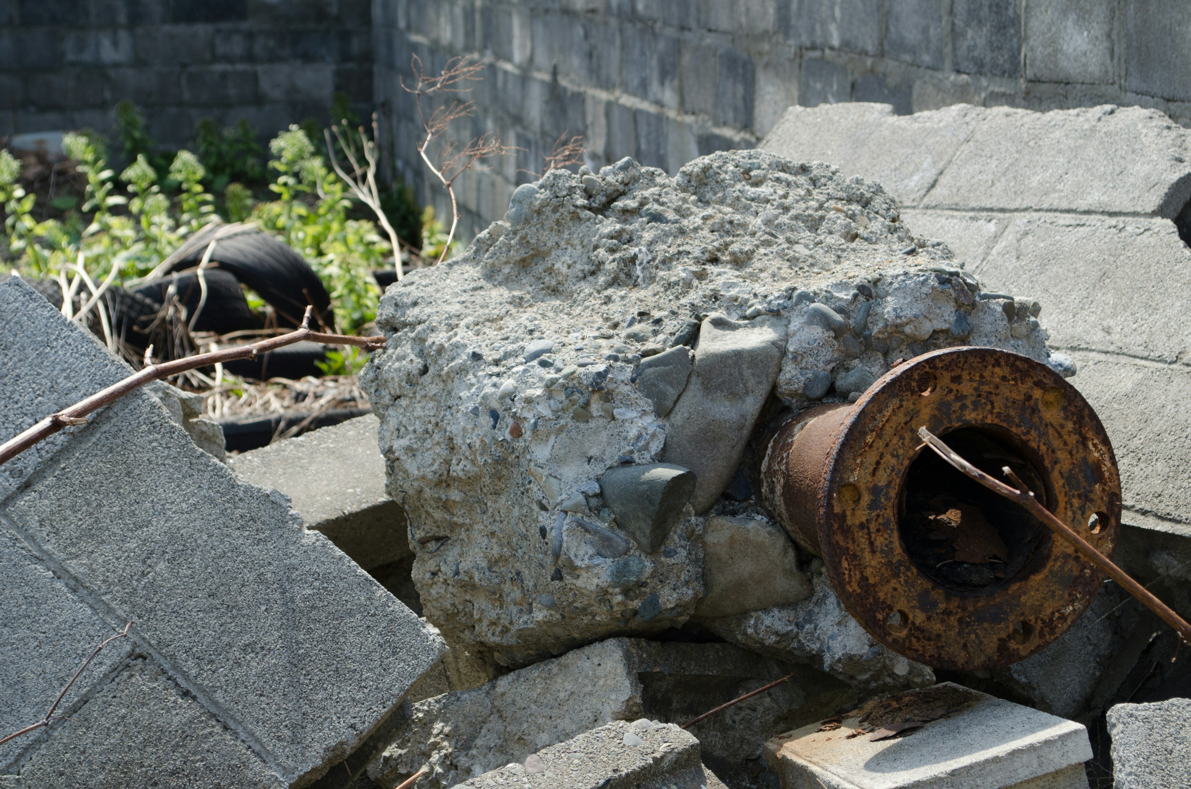 A scene of ruins featuring concrete blocks and a rusty metal piece