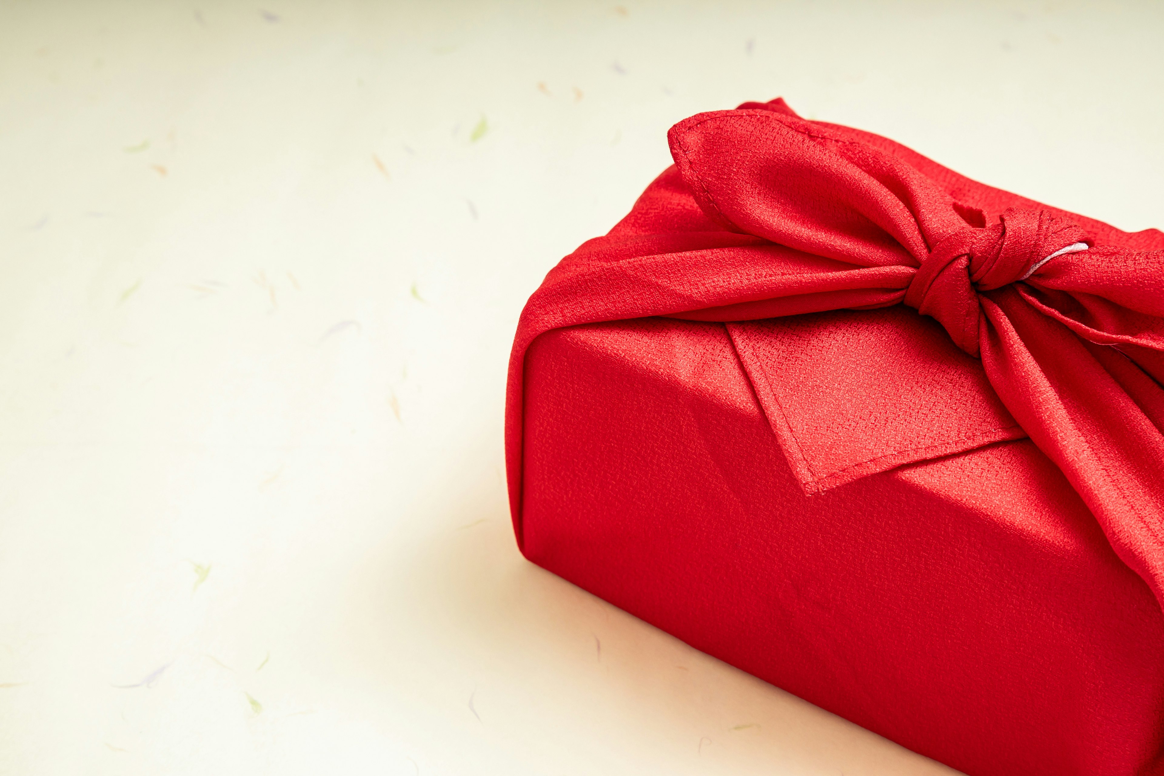 Close-up of a red wrapped gift box with a bow