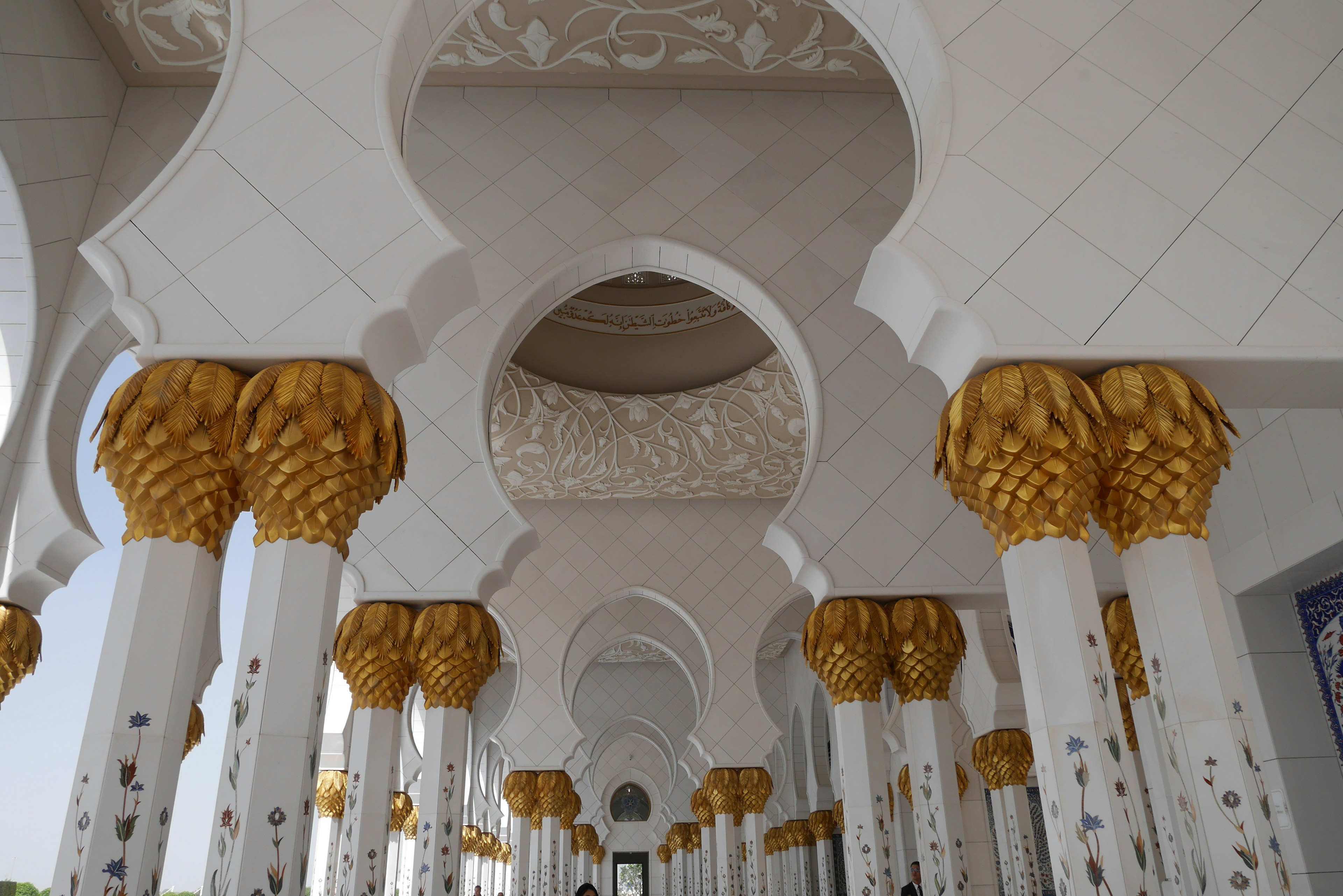 Interior of a beautiful building featuring golden pillars and arching ceilings