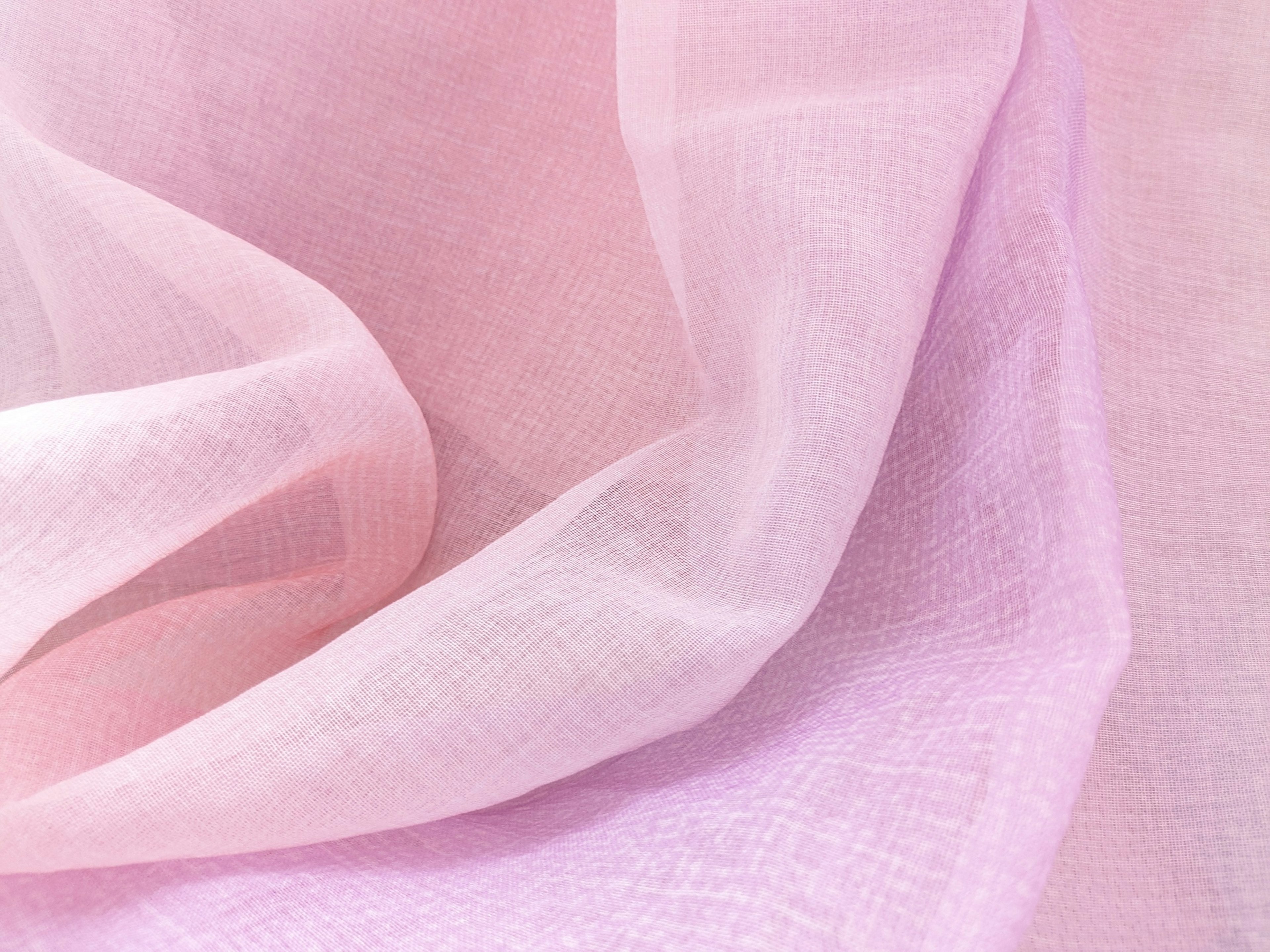 Soft pink fabric texture with delicate folds