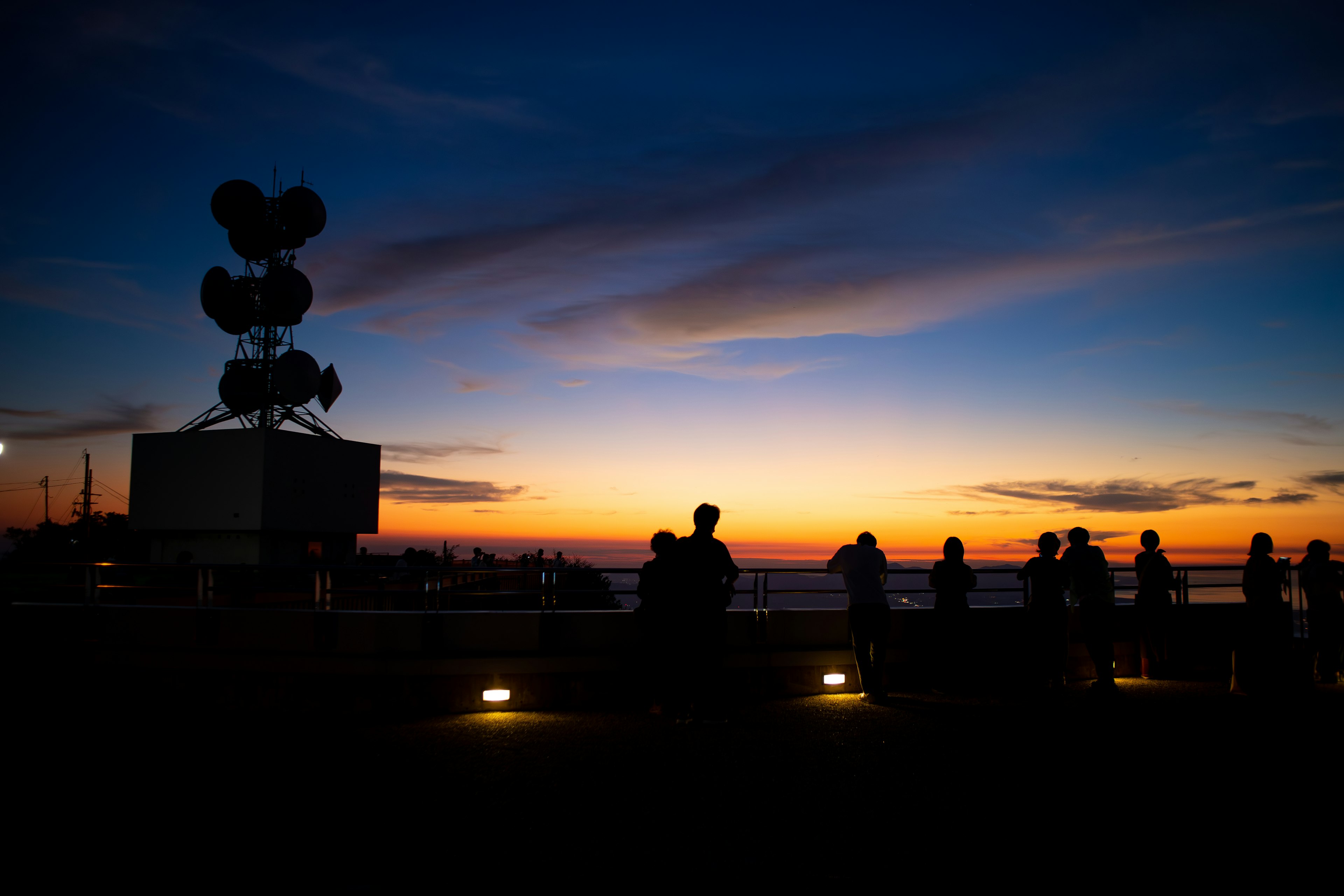 Silhouette of people against a sunset background