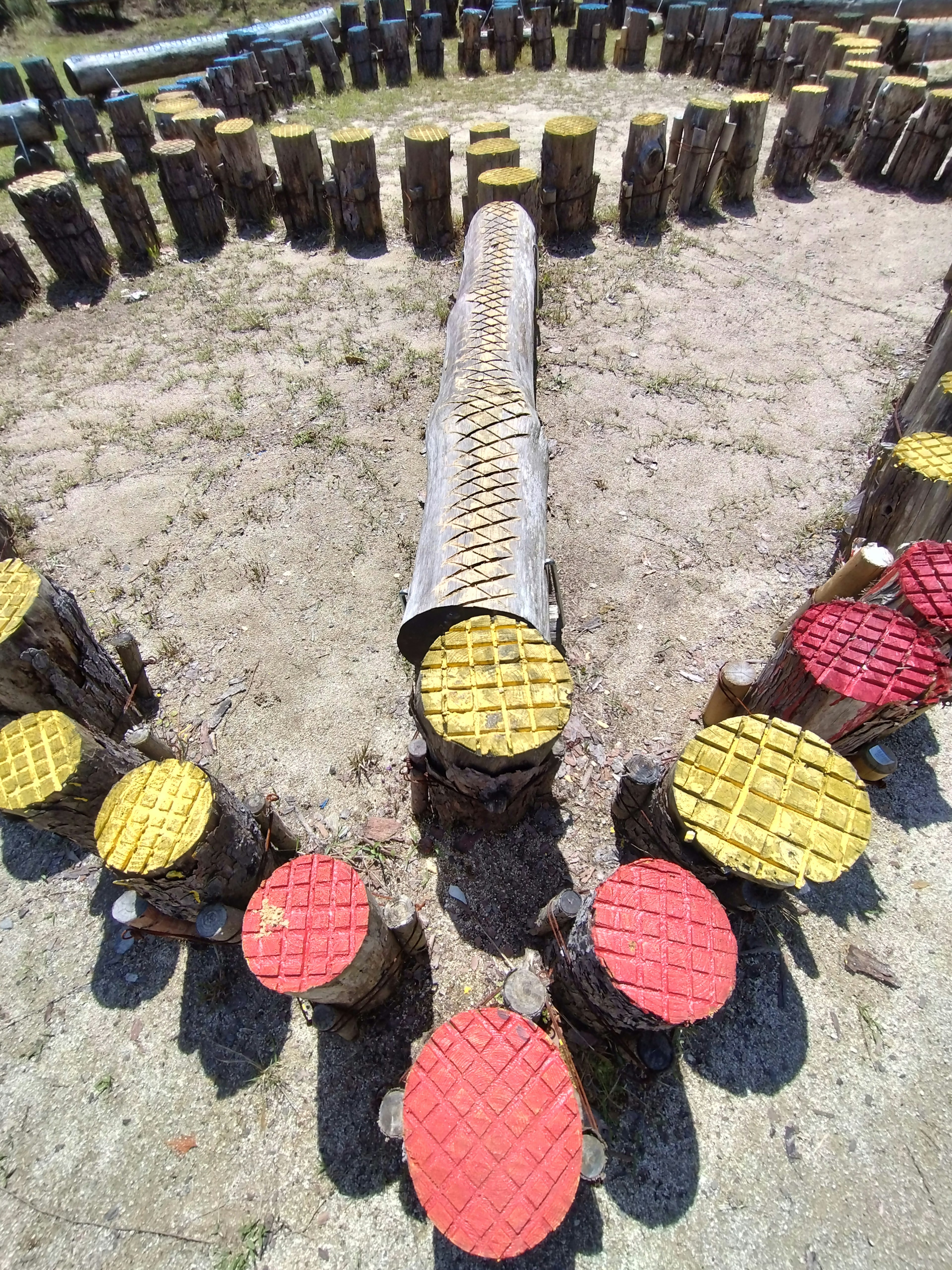 Colorful wooden stools arranged in a circular playground setting