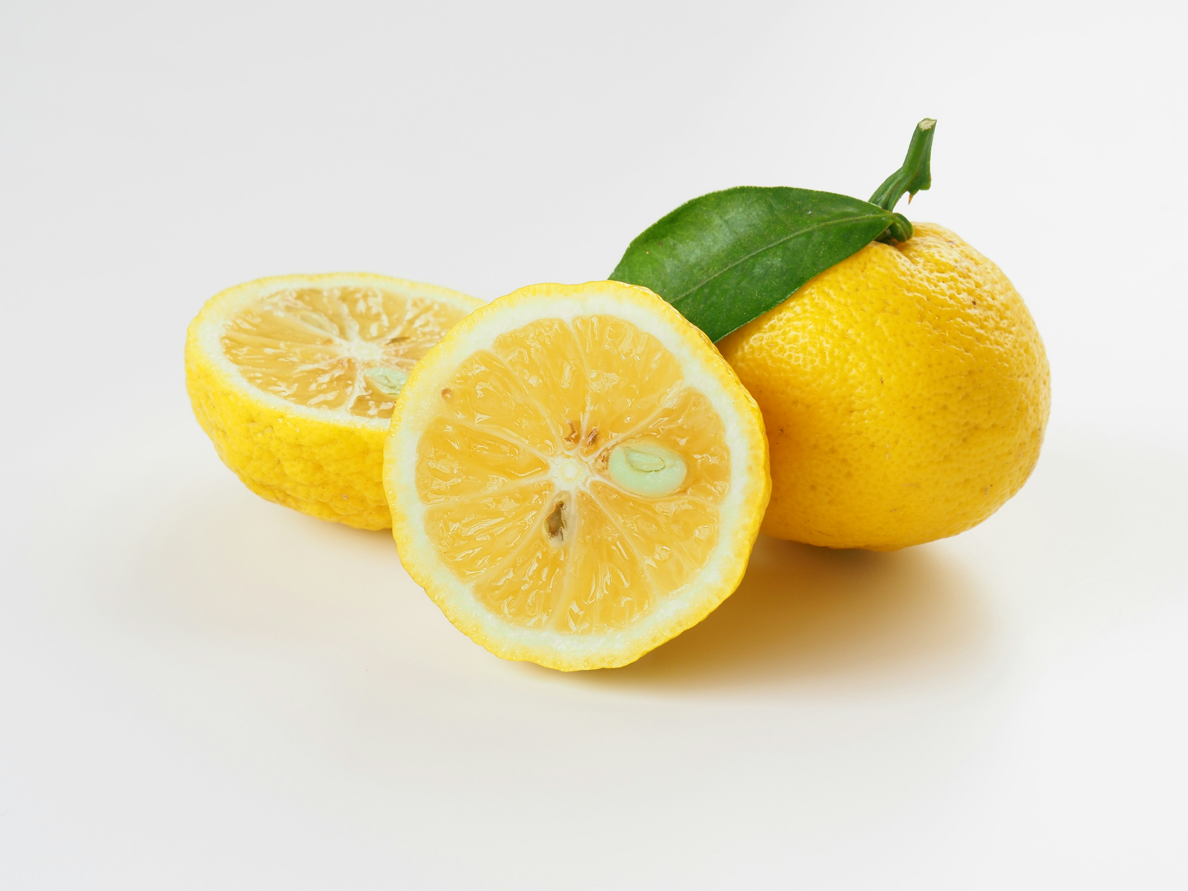 Fresh lemon with a cut showing its juicy interior on a white background