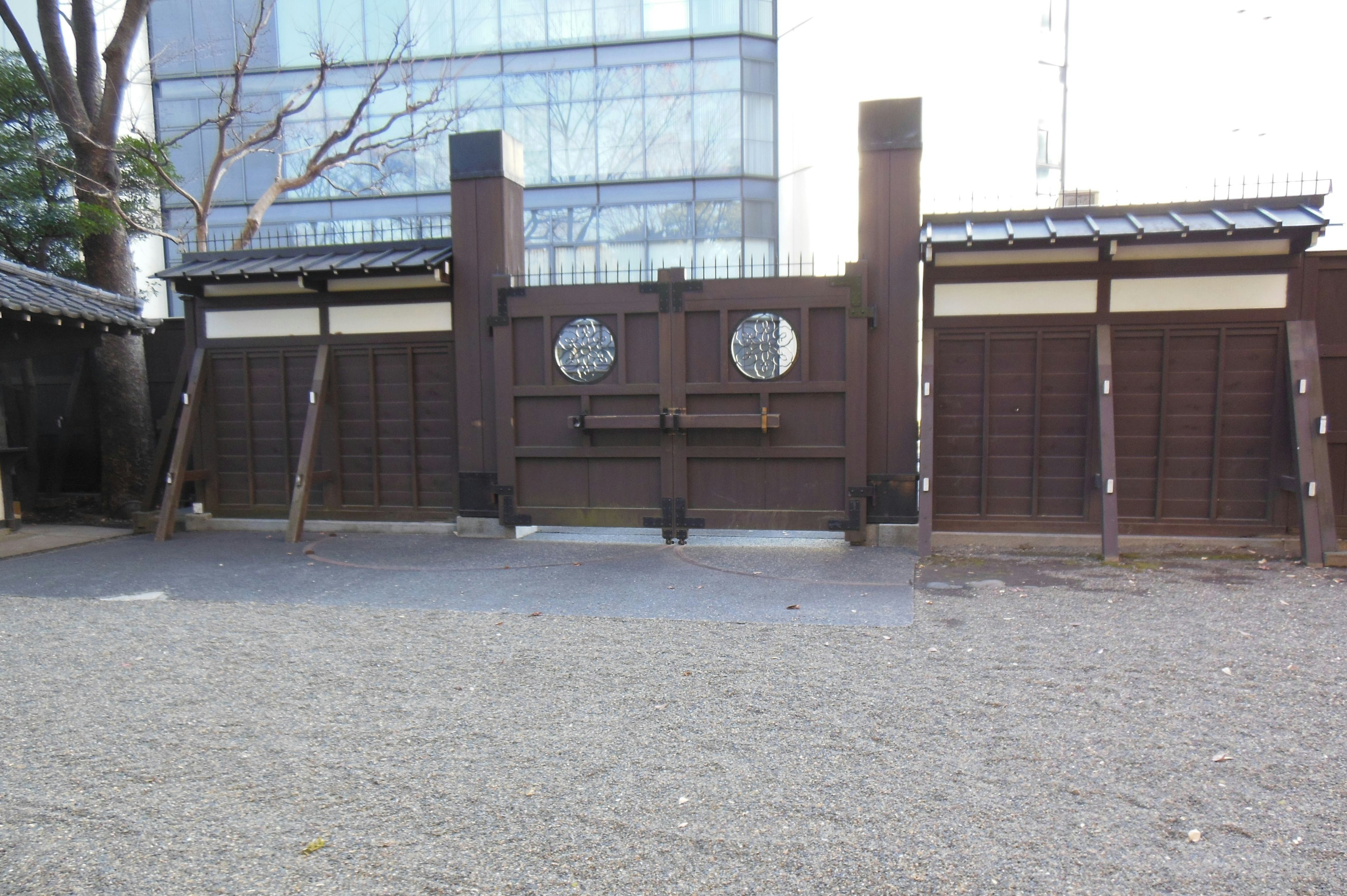 Porte japonaise traditionnelle contrastant avec un bâtiment moderne