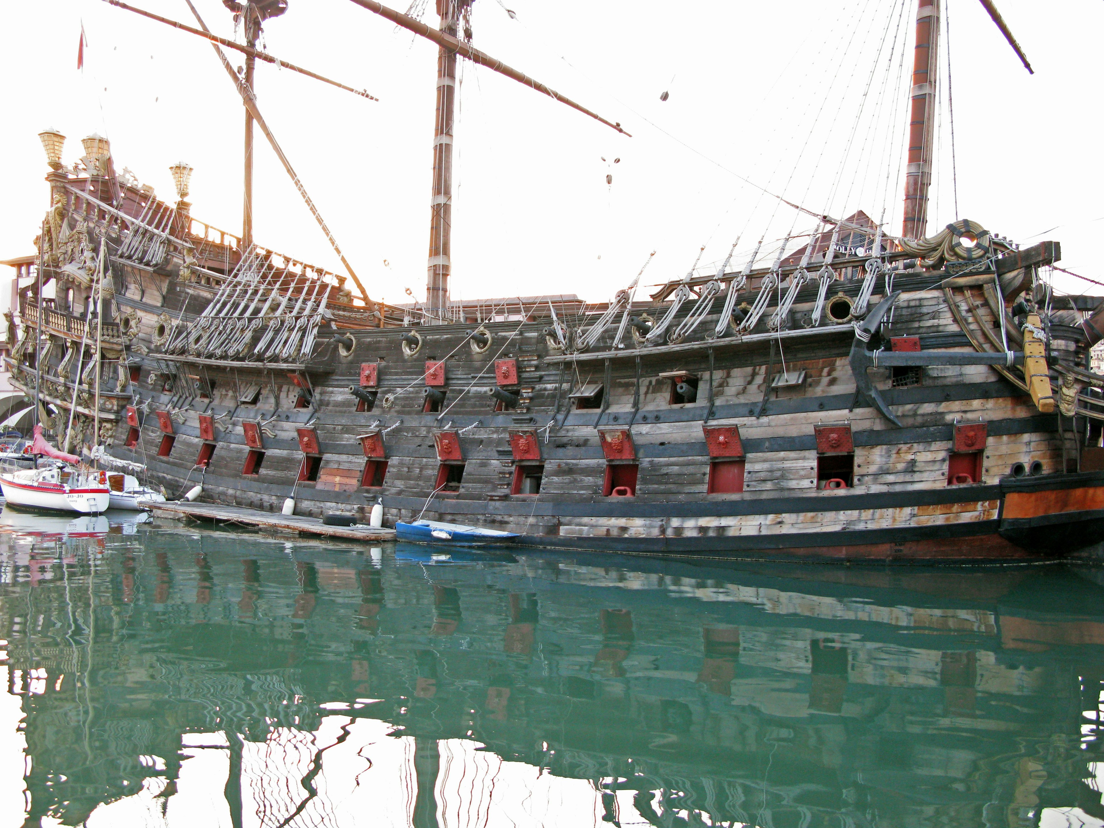 An old wooden ship docked on calm waters