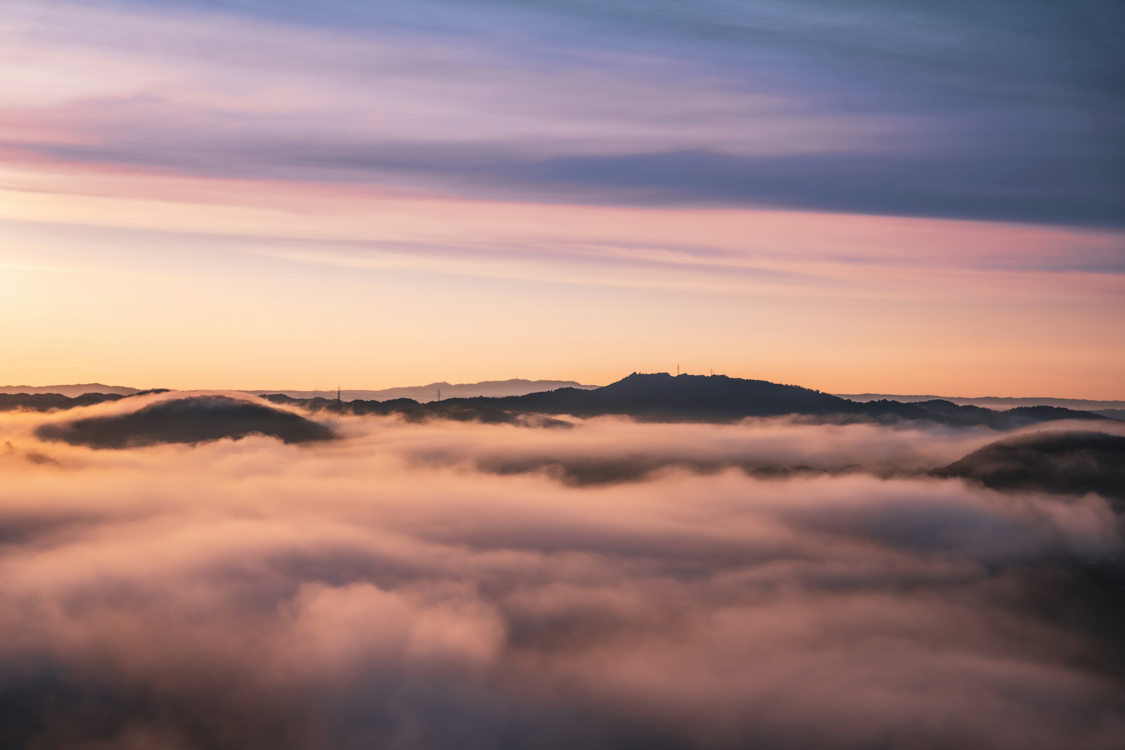 Beautiful sunset landscape with mountains shrouded in clouds