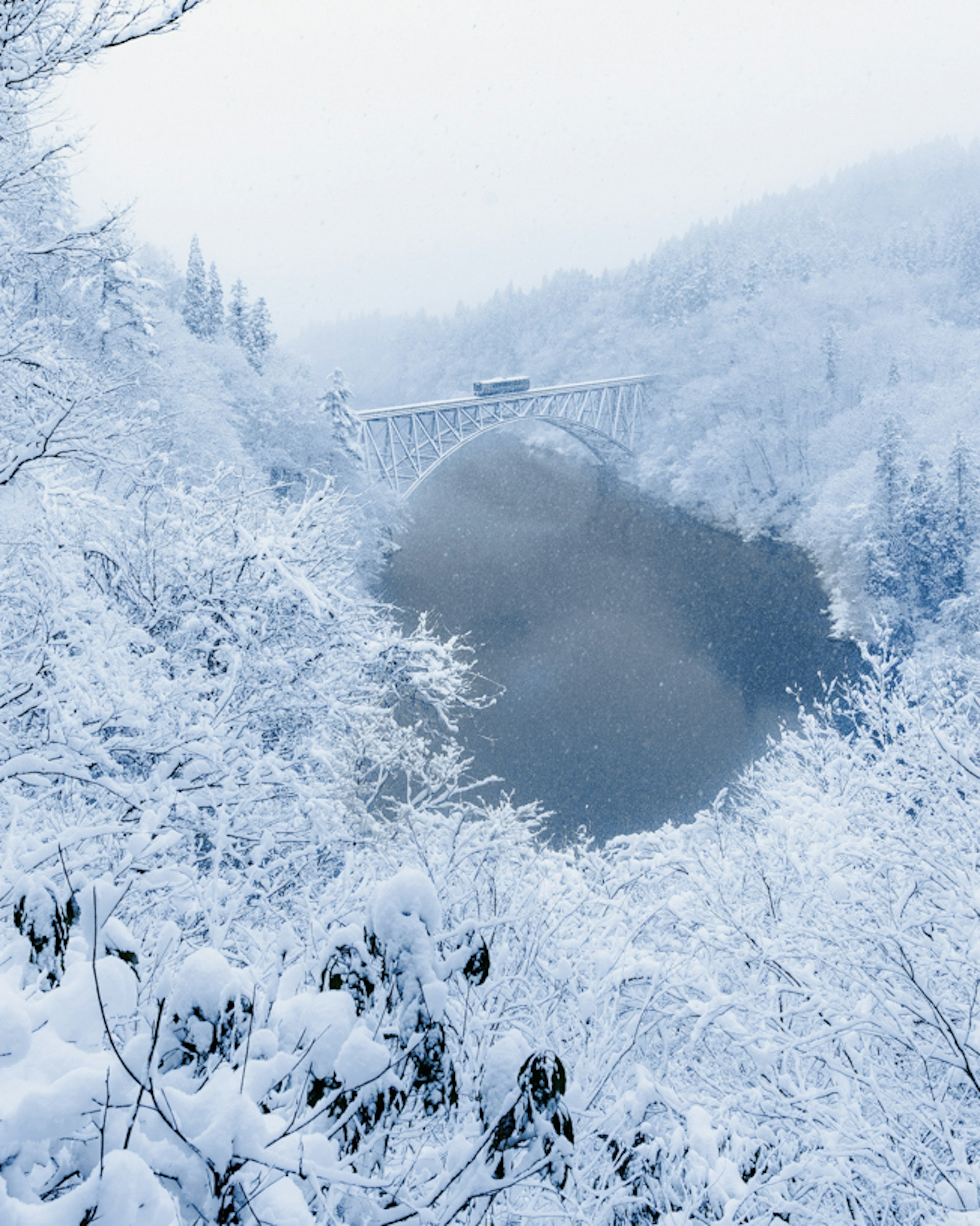 Snow-covered bridge and mountain landscape