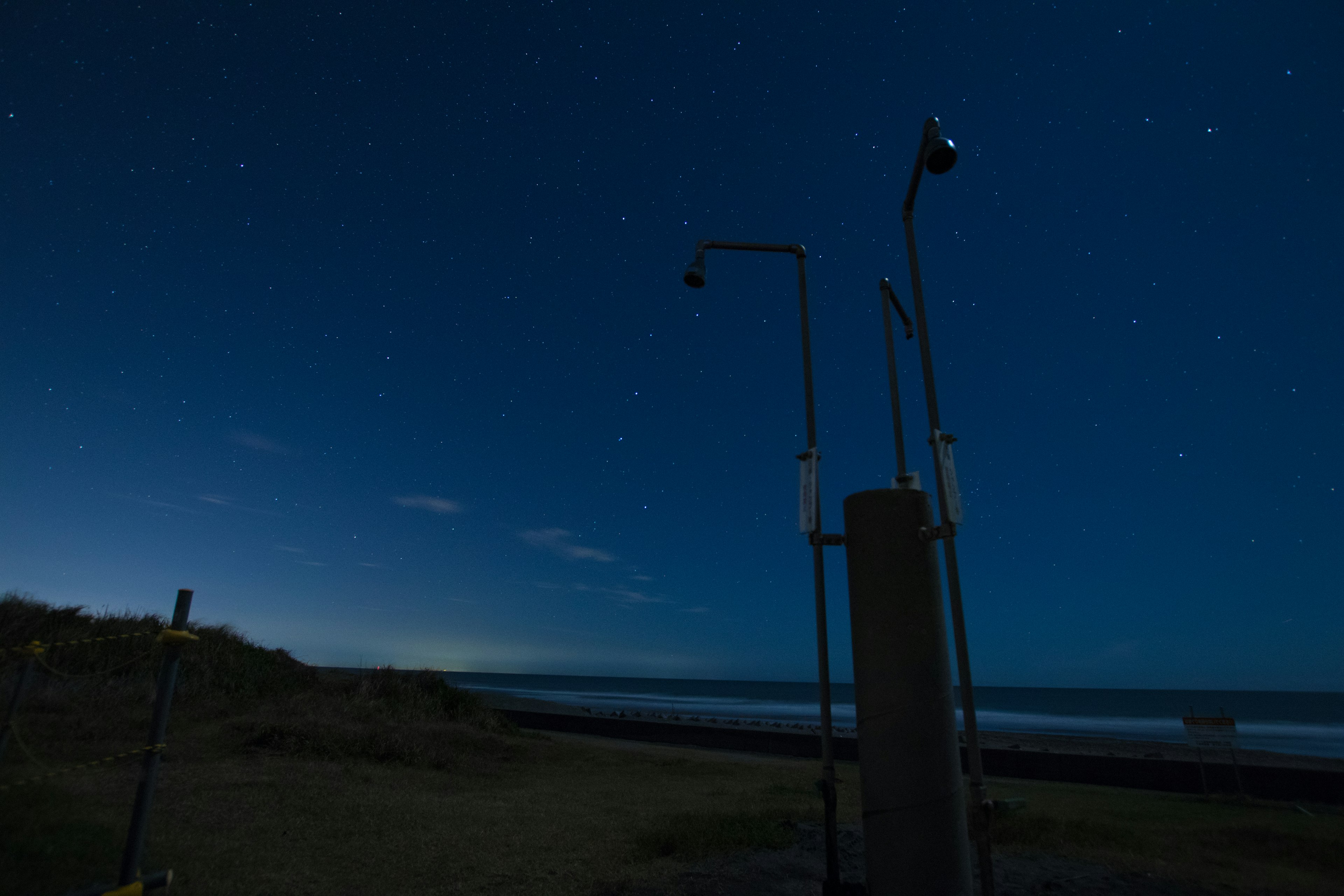 Scena costiera notturna con stelle e attrezzature