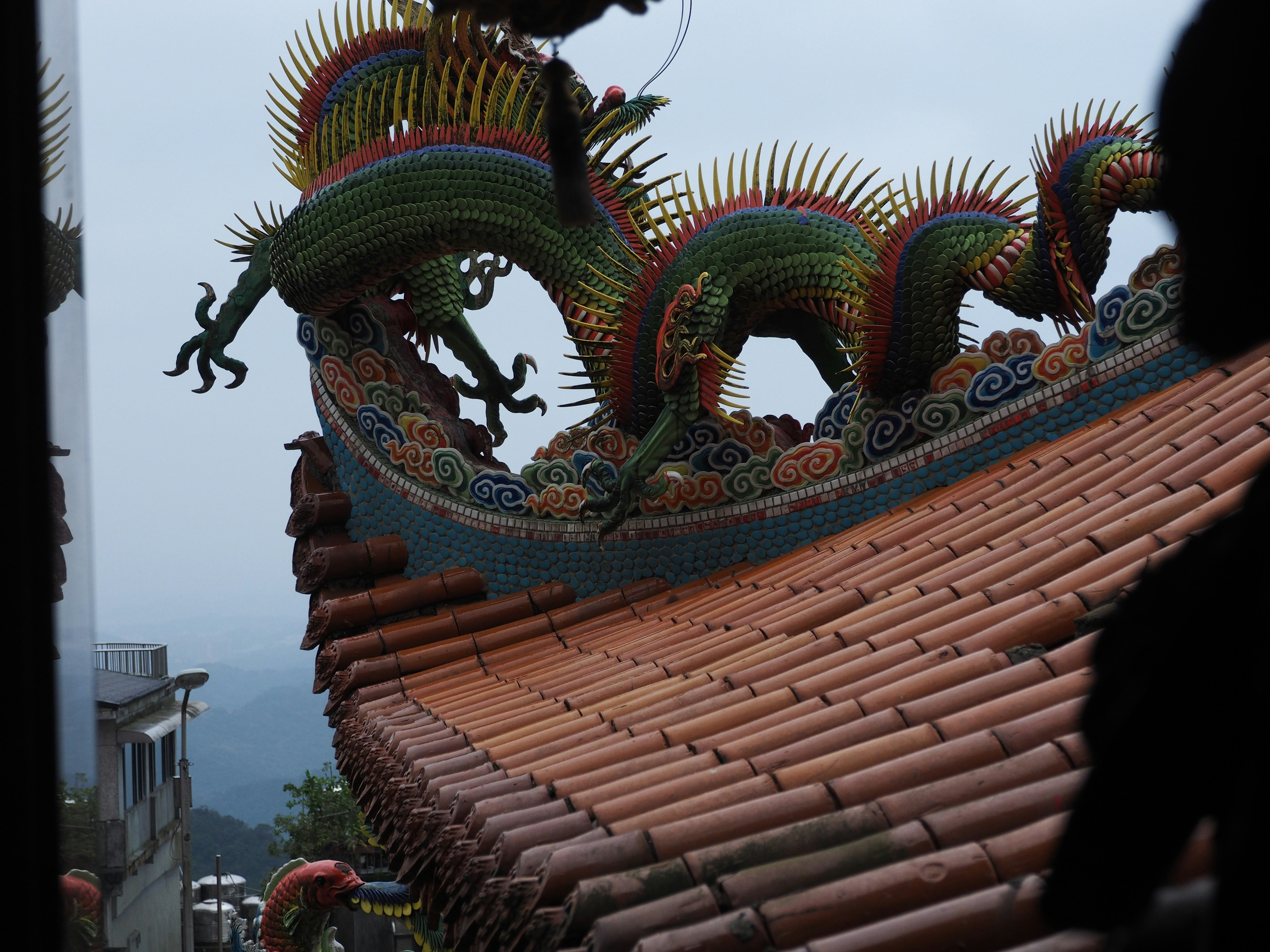 Colorful dragon sculptures on a traditional roof