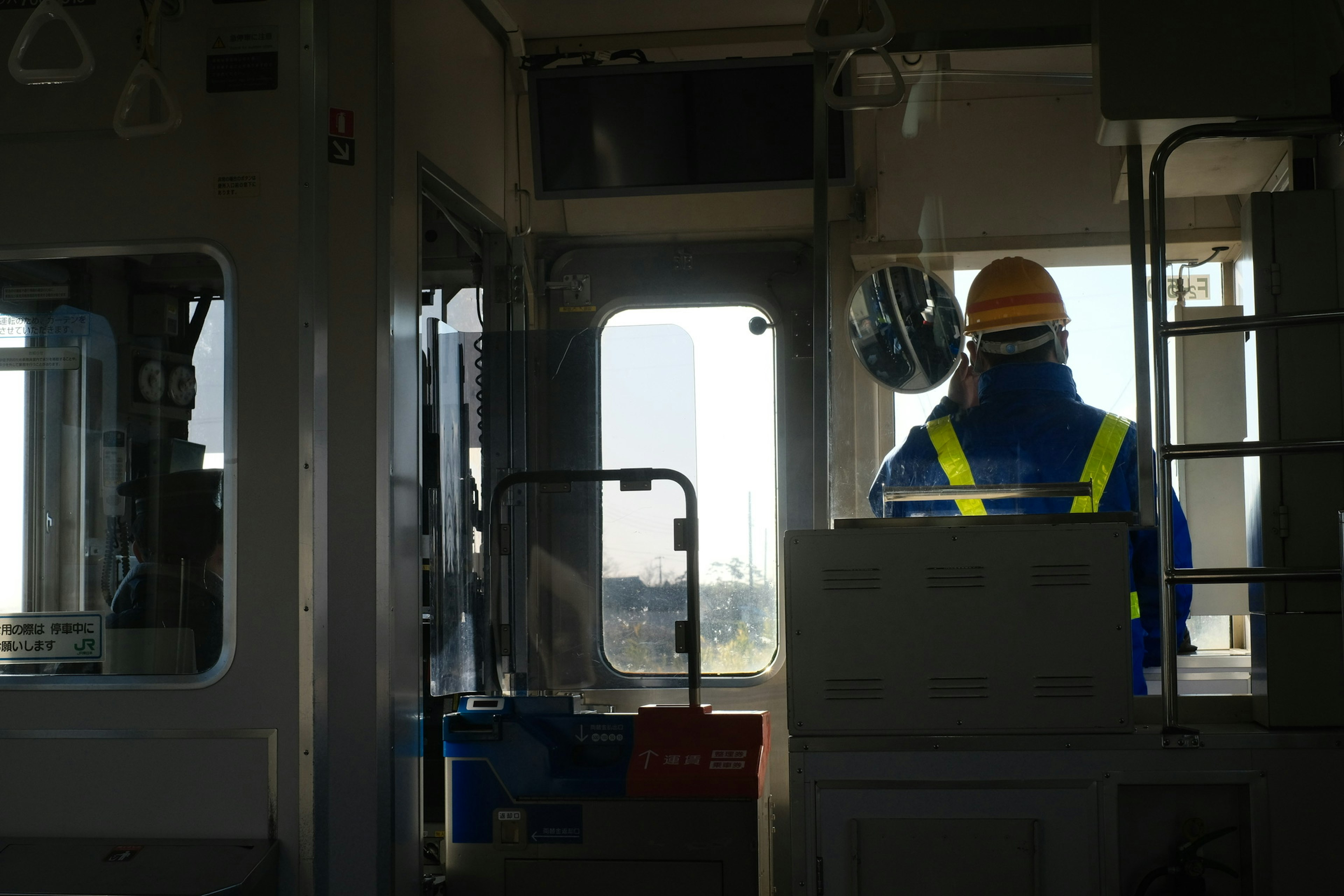 A worker in a control cabin looking outside