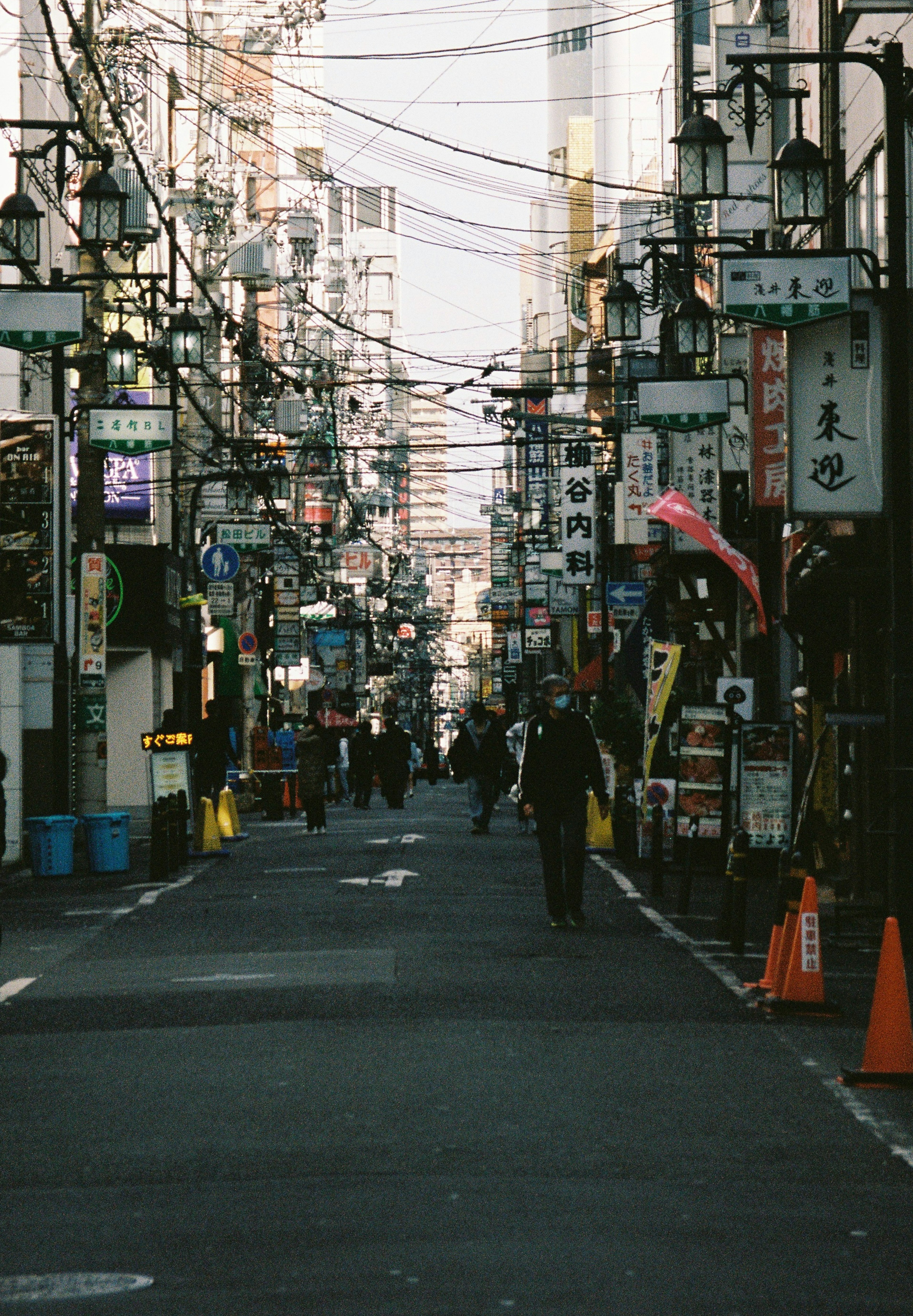 Bustling street lined with shops and signs featuring vibrant colors