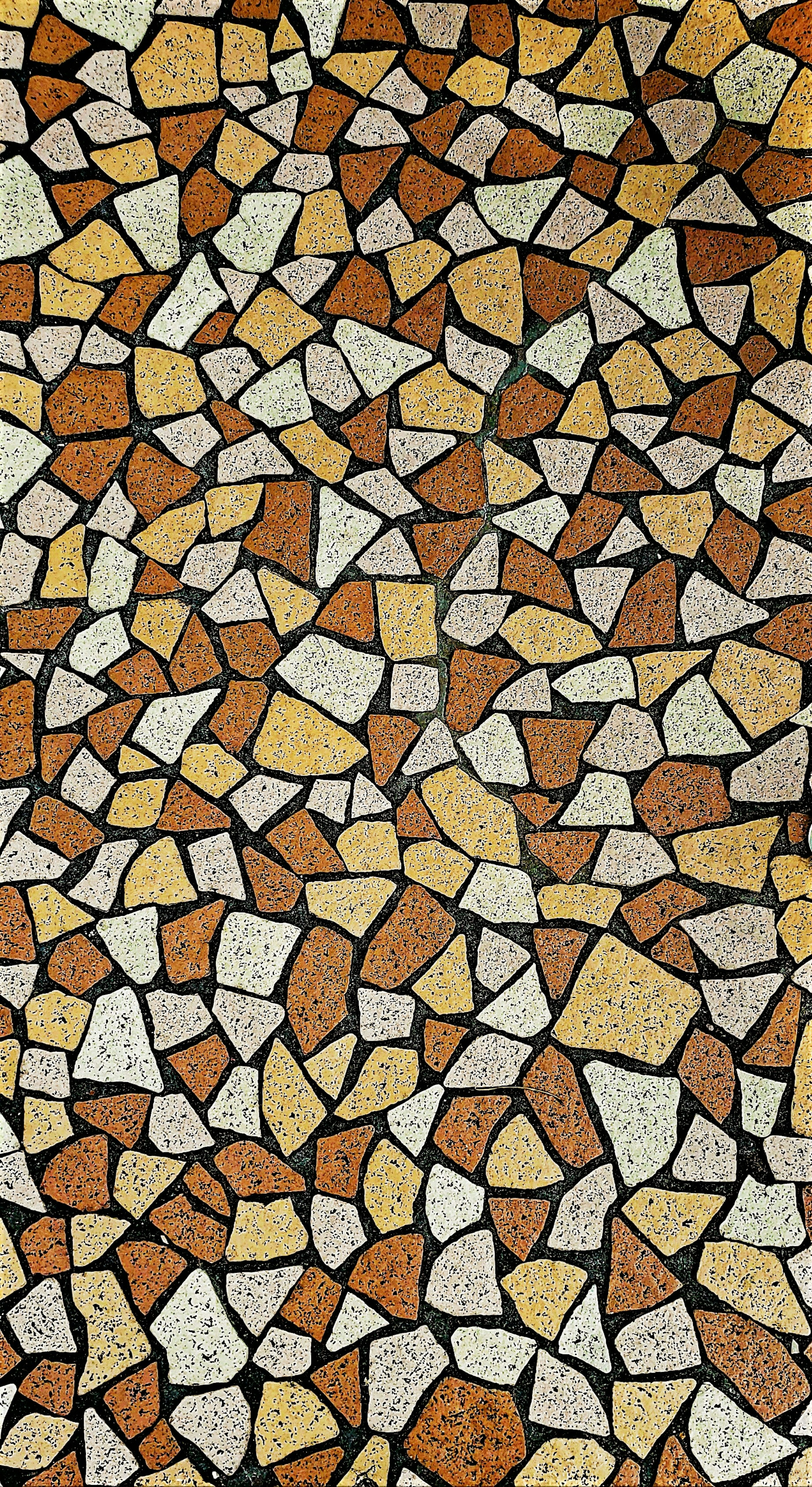 Suelo de mosaico hecho de piedras coloridas dispuestas en patrones únicos