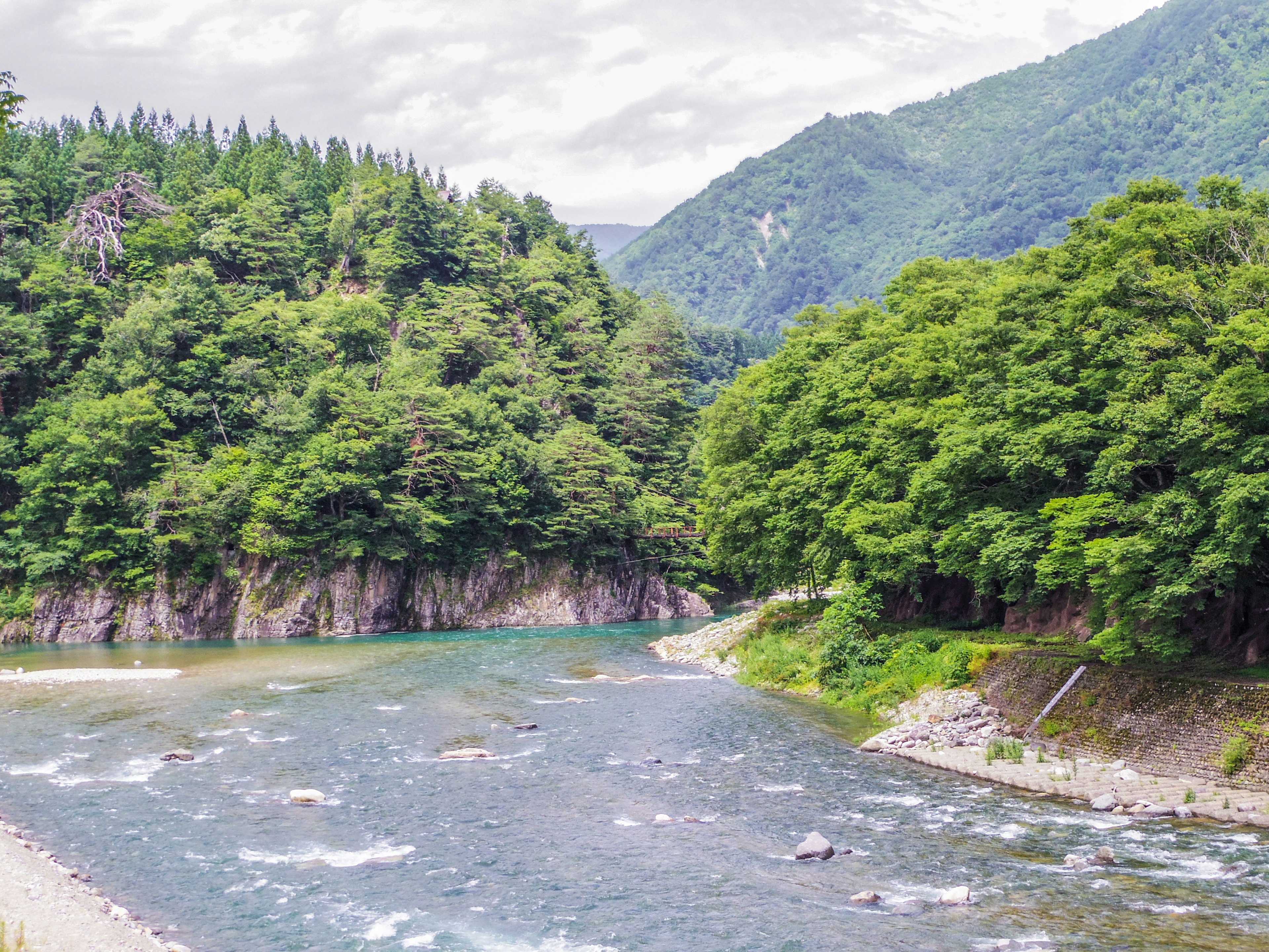 Lush green mountains and a clear river landscape