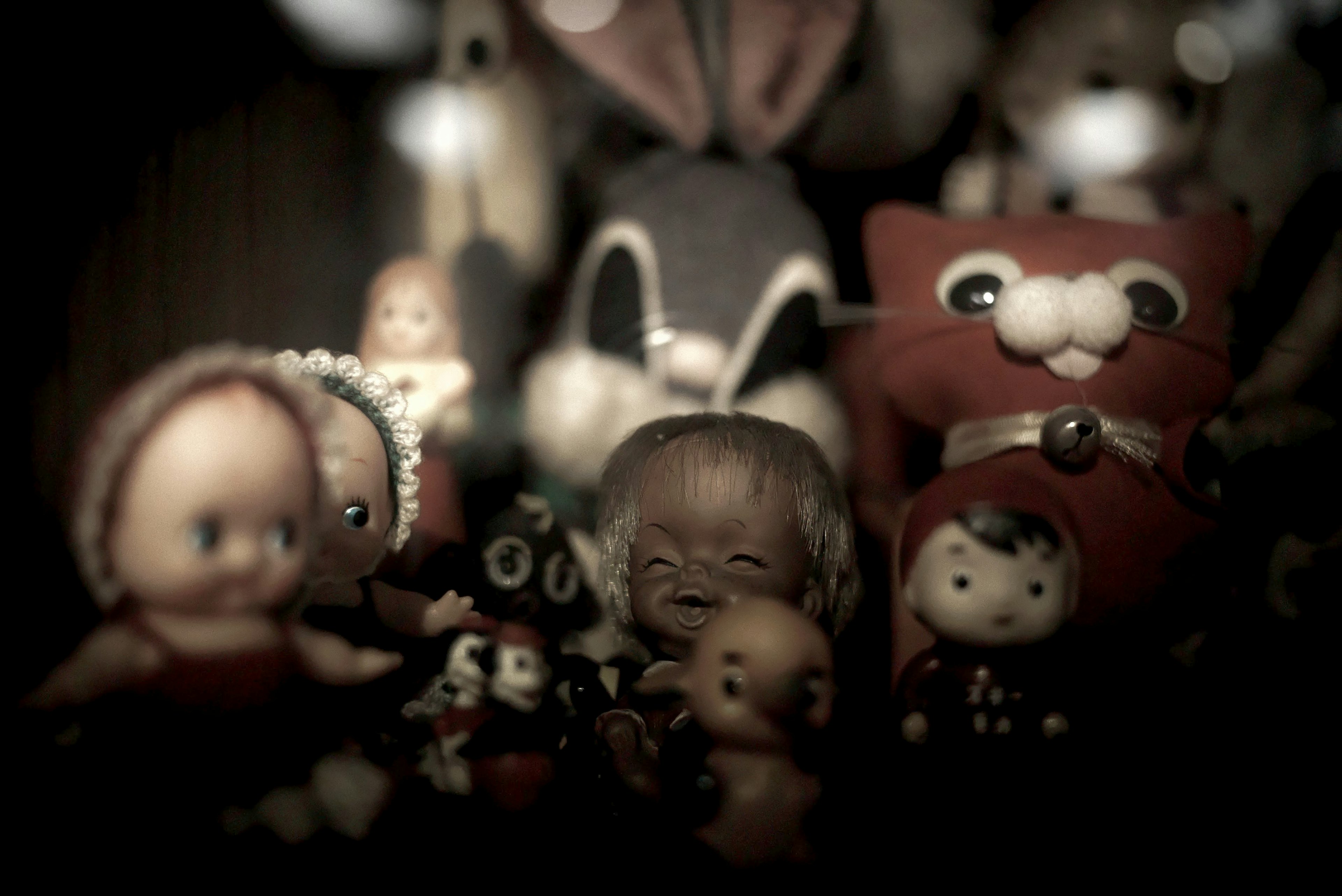 A retro display featuring a variety of dolls in the background