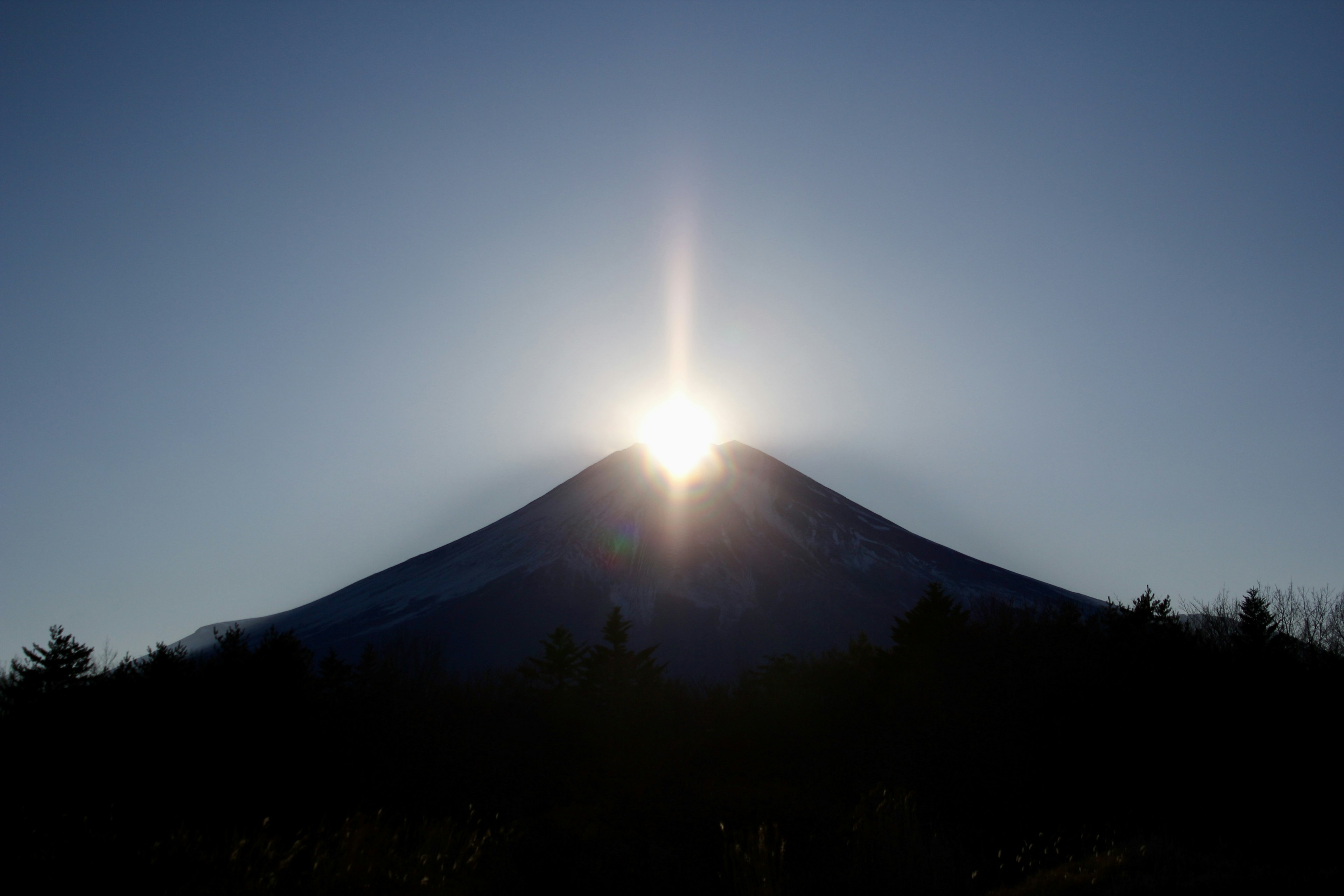 Sunrise shining over the peak of Mount Fuji