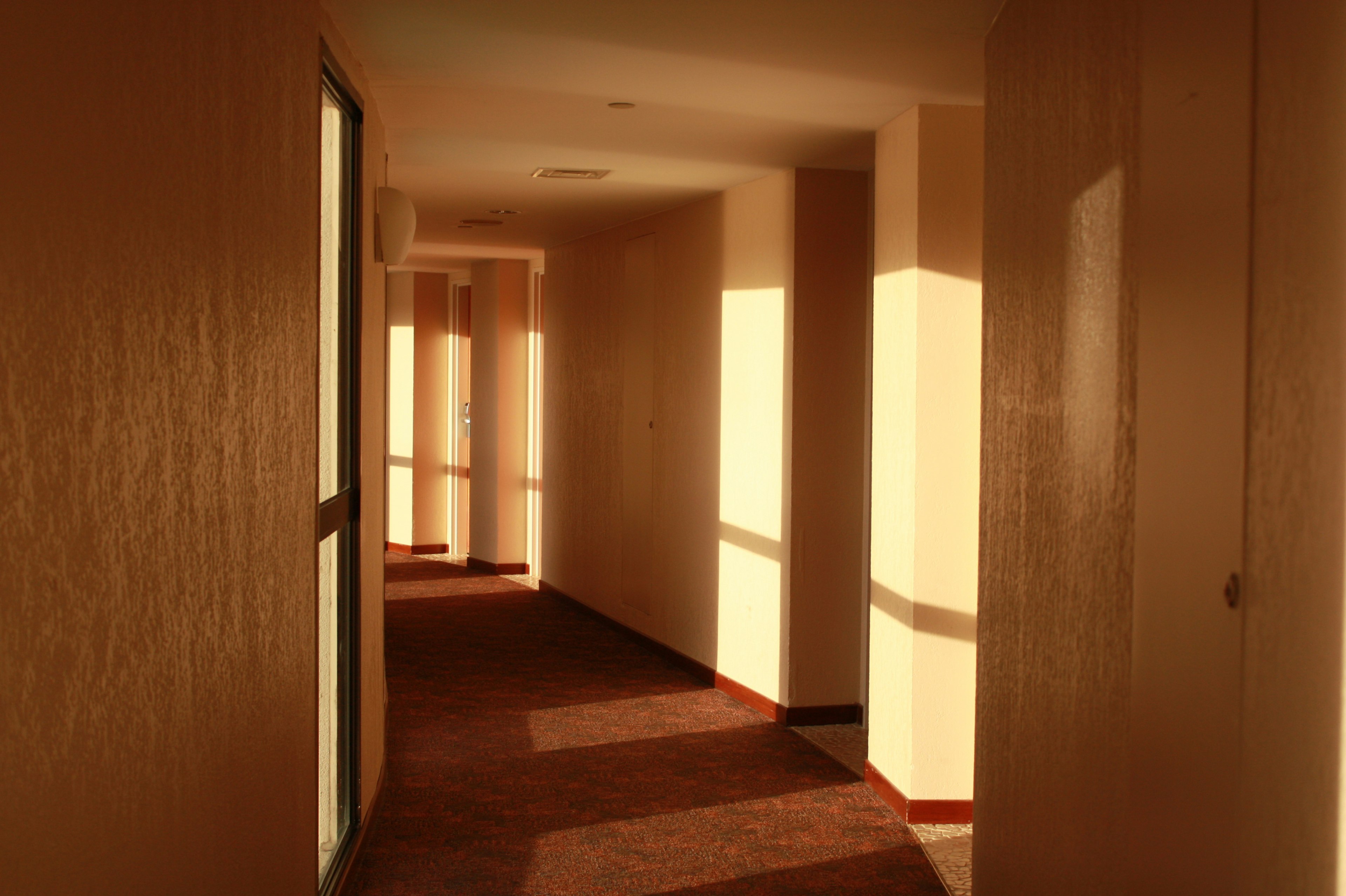 Brightly lit hallway with light and shadow