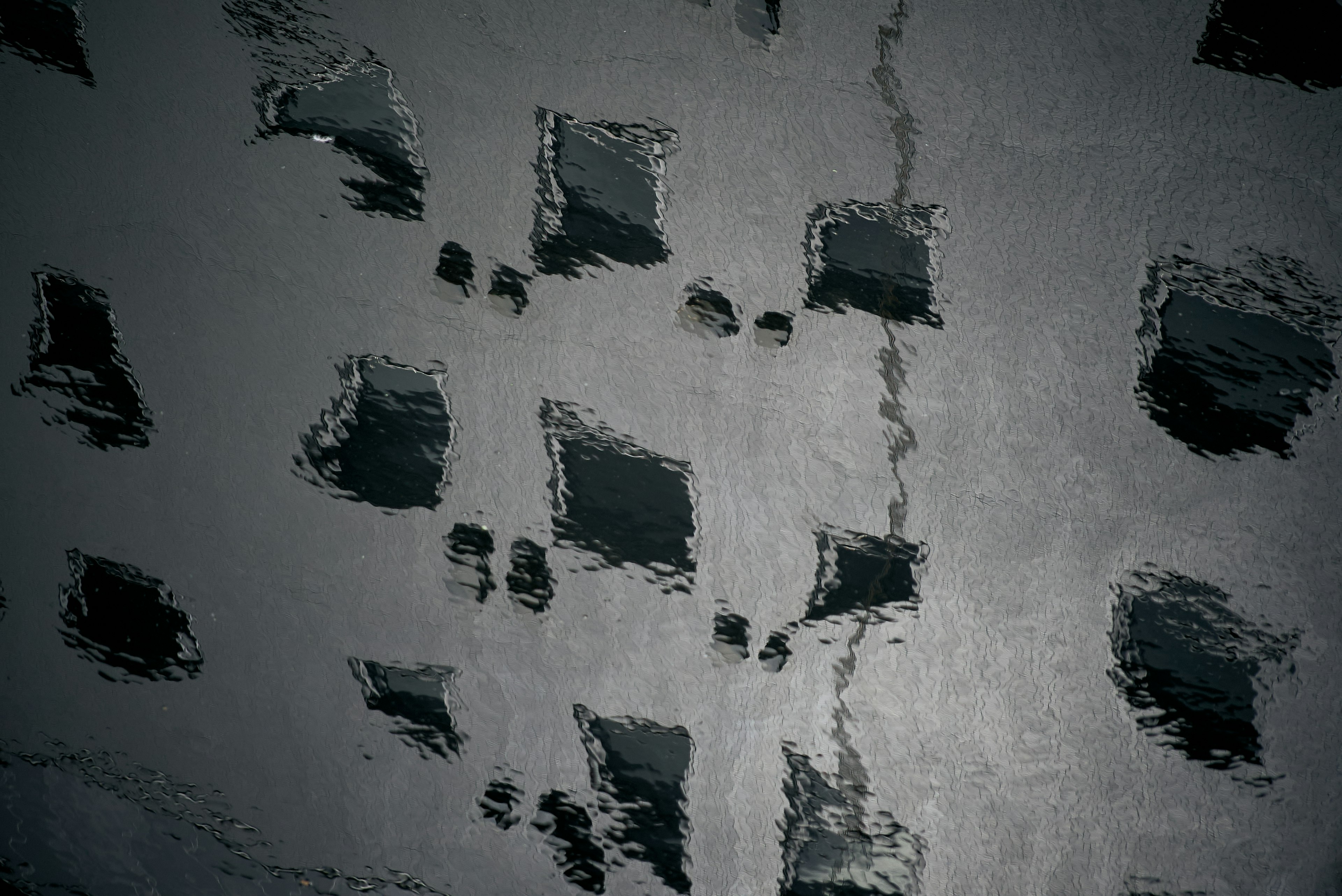 Textured black wall with irregular holes