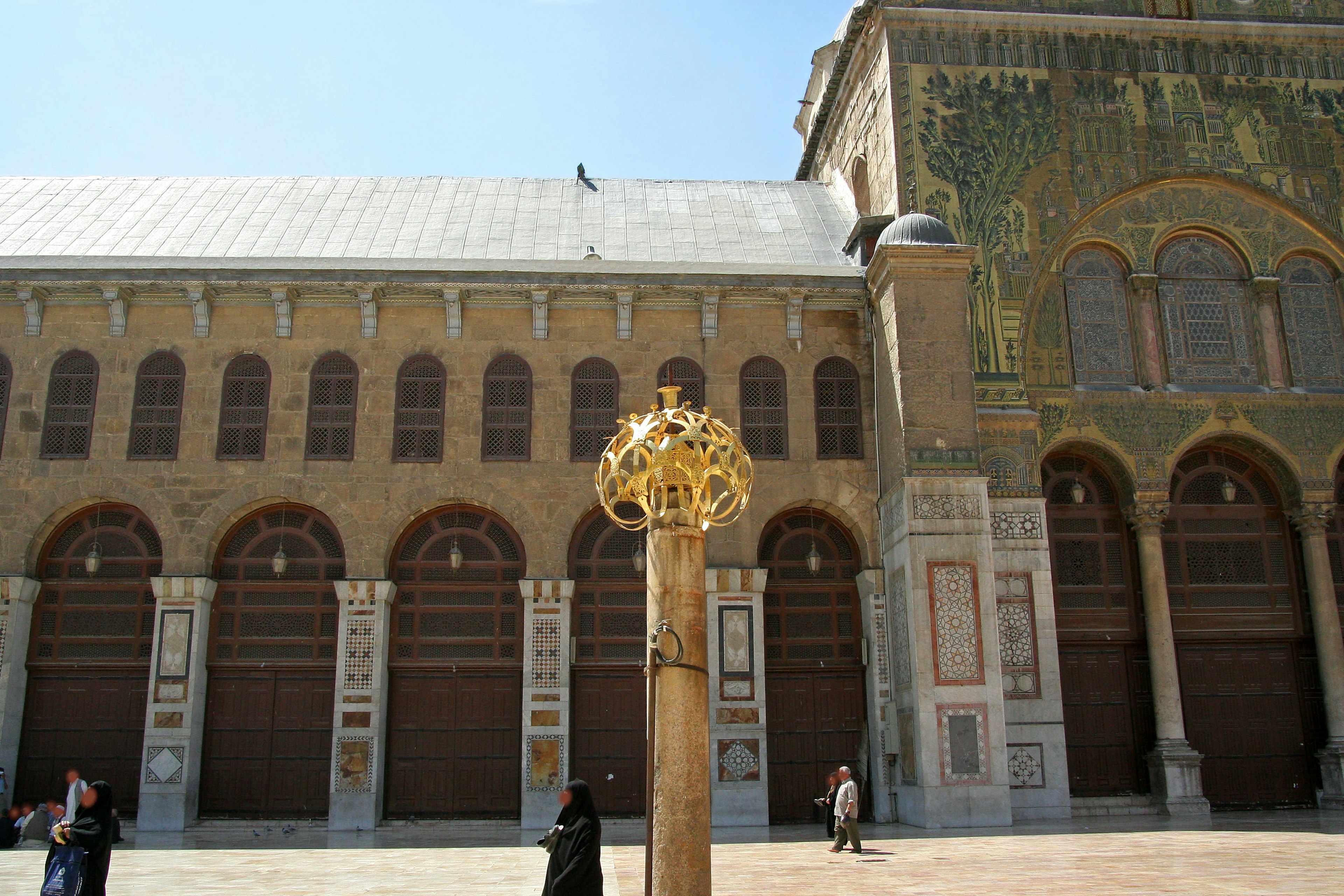 Historical building exterior featuring a decorative golden column