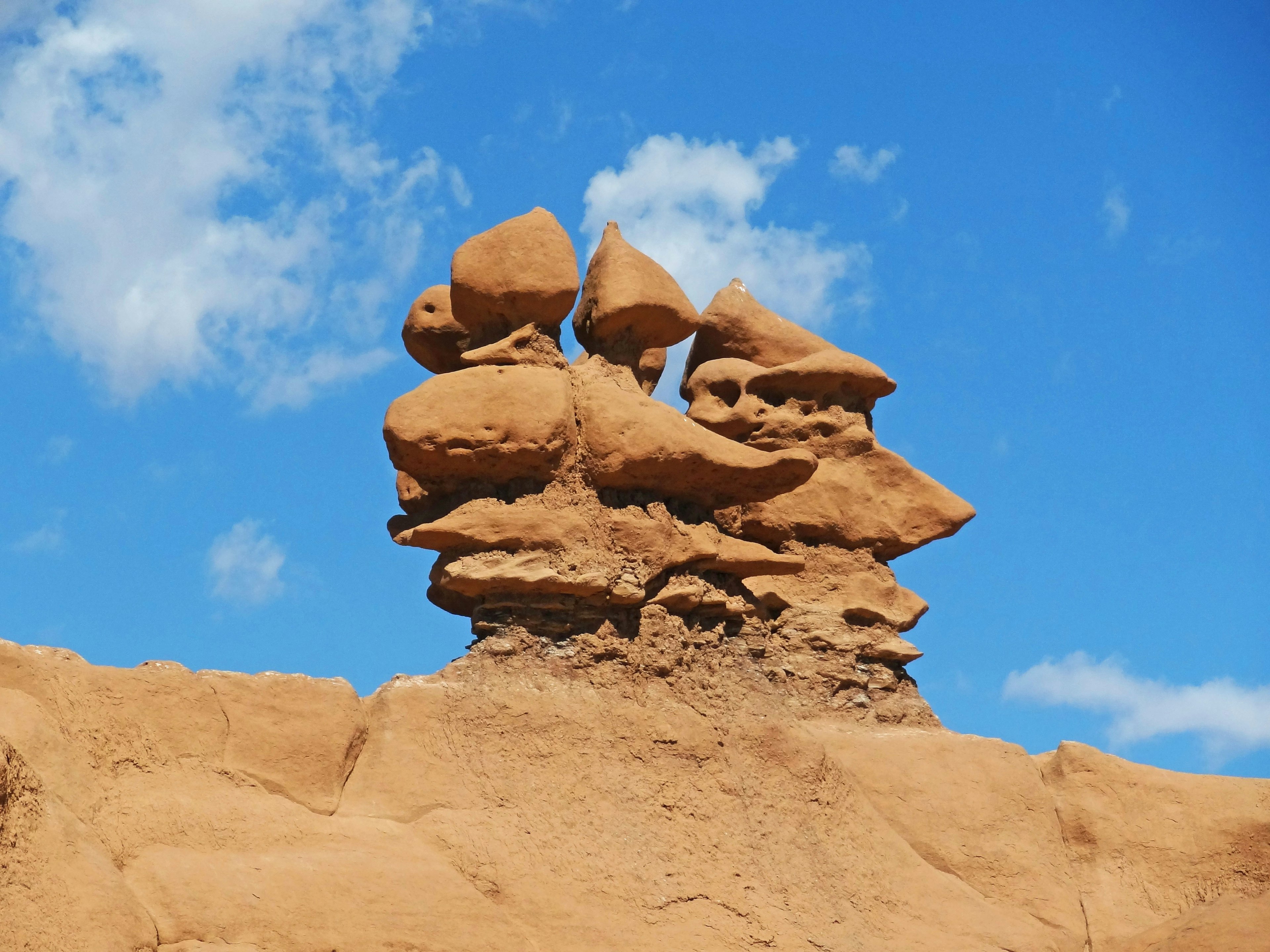 Unique sandstone rock formation under a blue sky