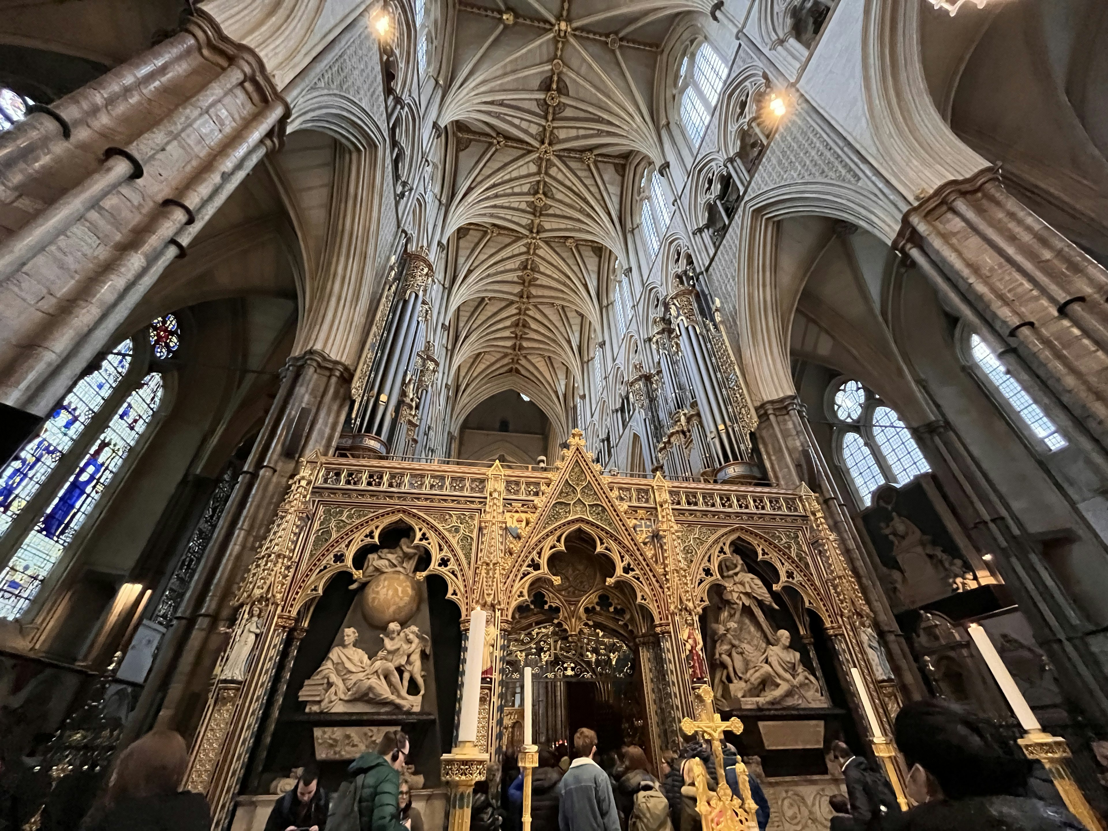 Grand interior of a church with Gothic ceiling and intricately carved altar